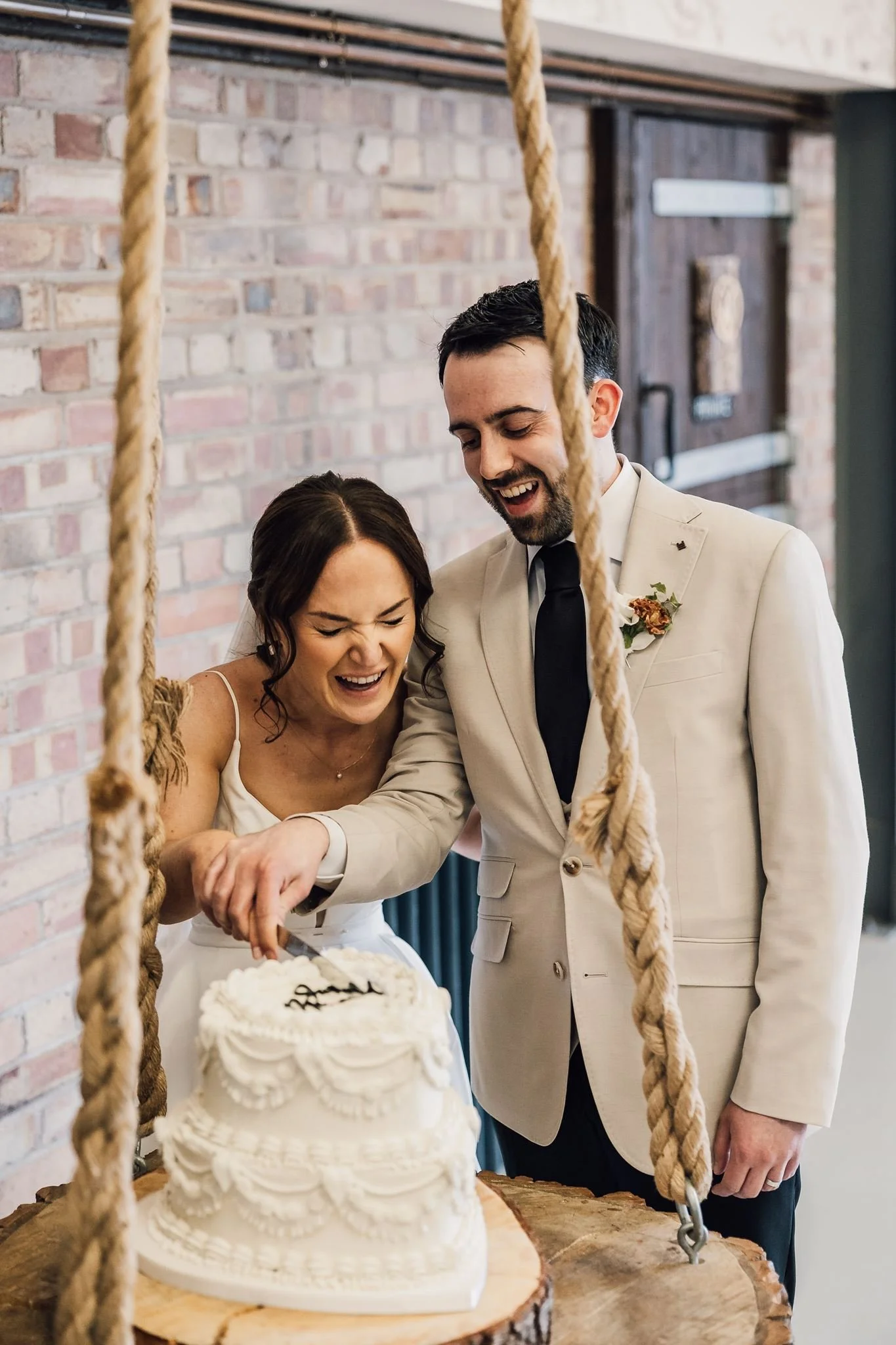 Rachel laughing beside Harry during the wedding speeches