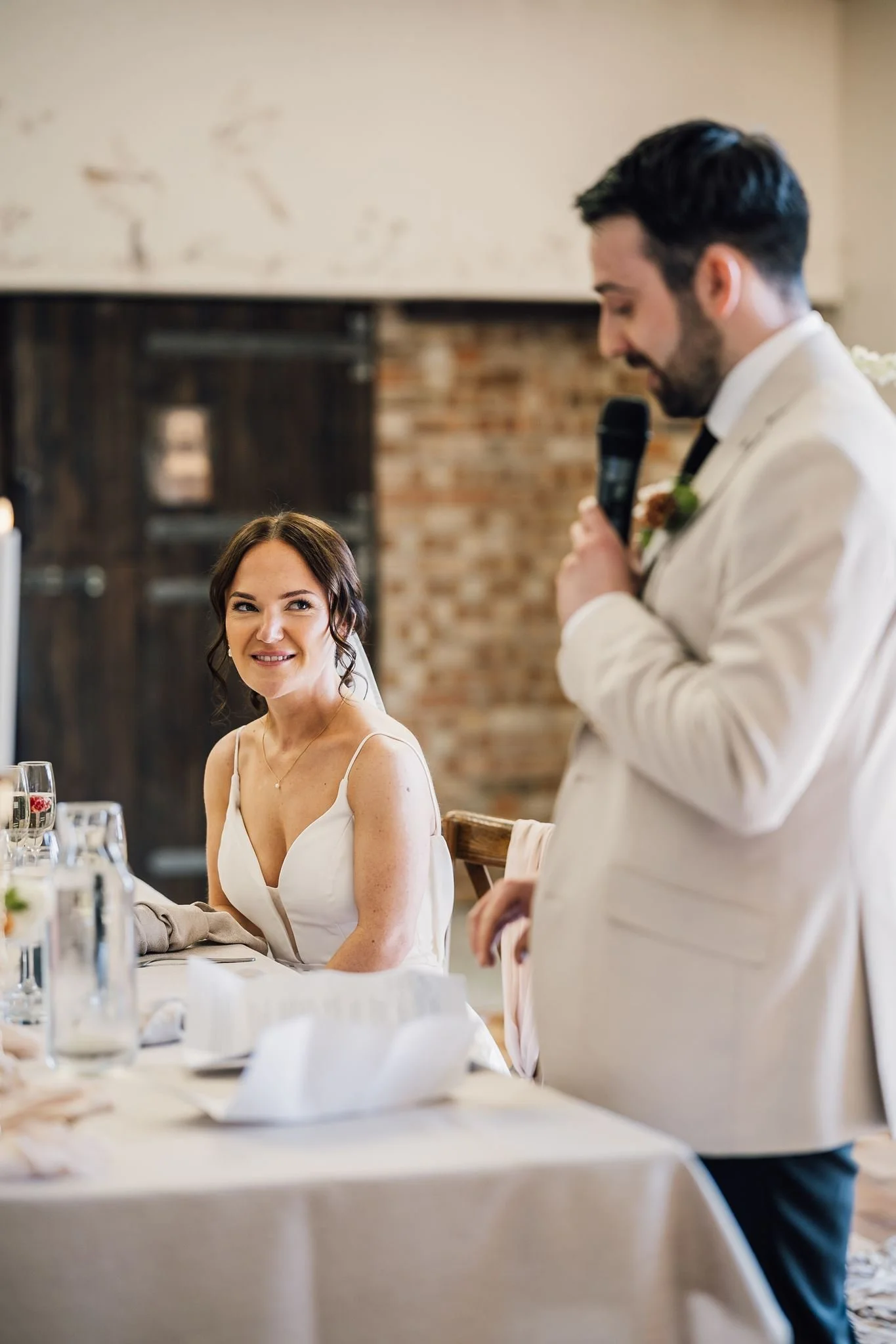 Harry giving his wedding speech while Rachel smiles beside him