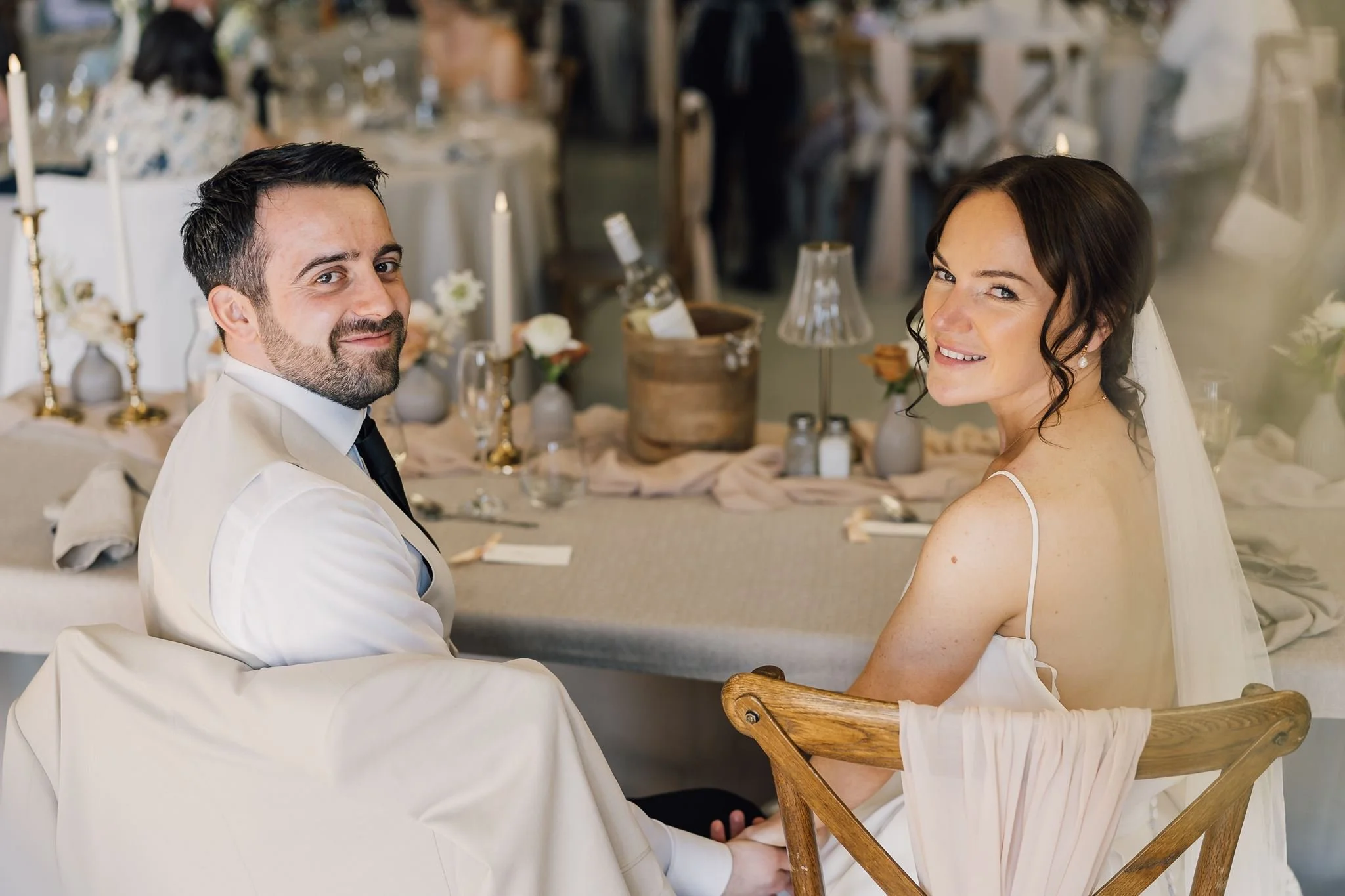 Rachel and Harry smiling at the top table during their wedding breakfast