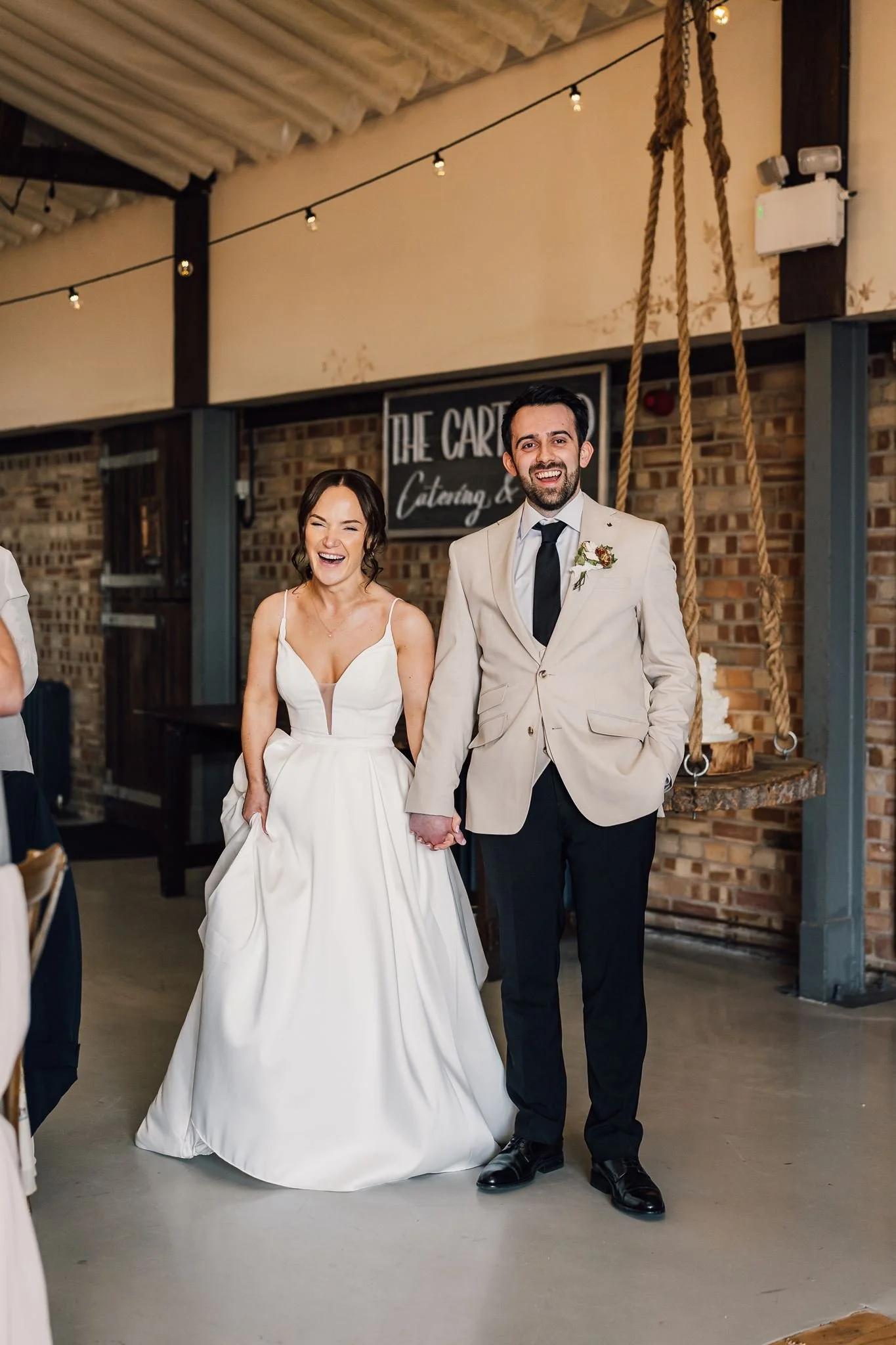 Rachel and Harry entering the barn together for their first dance