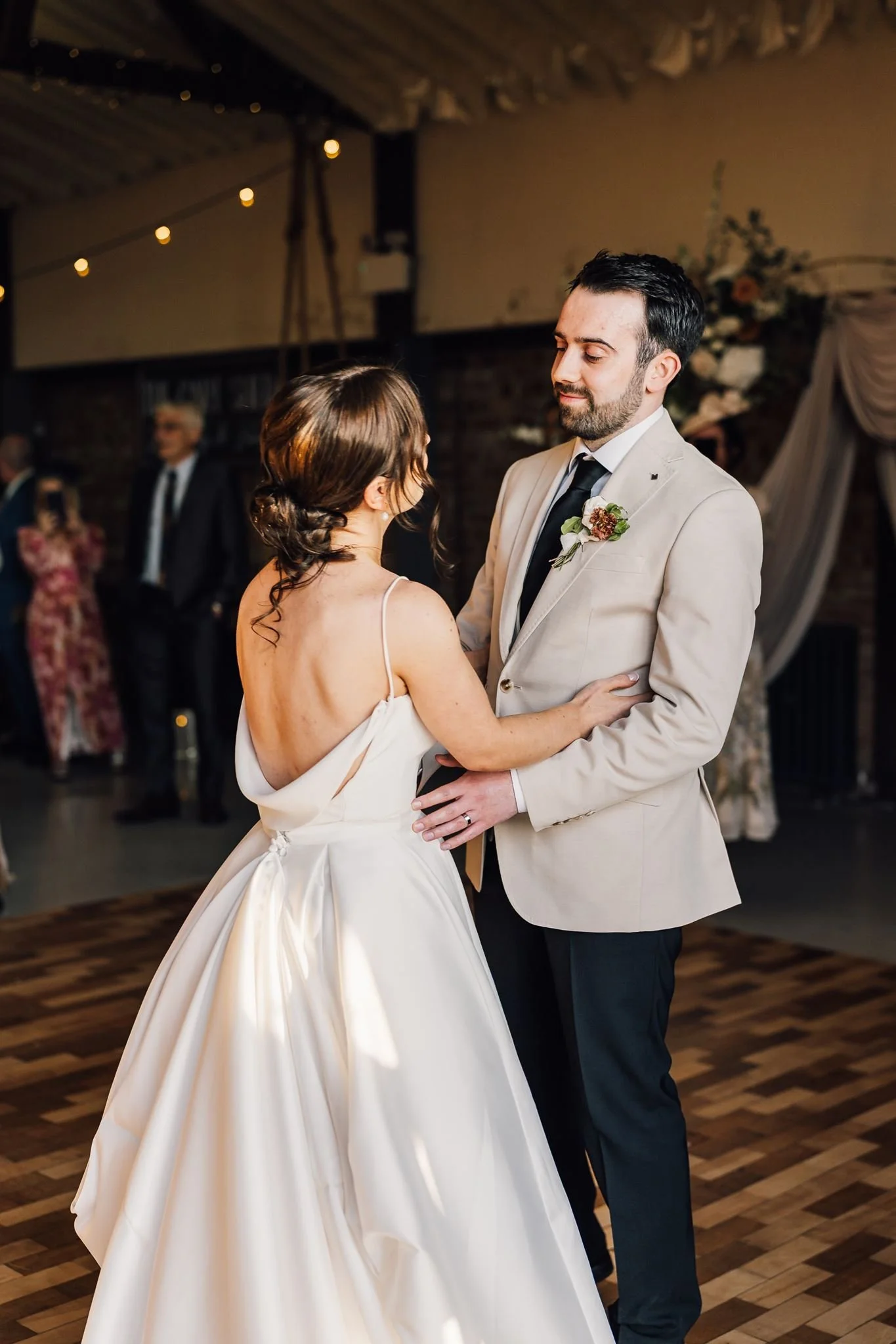 Rachel and Harry smiling at each other during their first dance