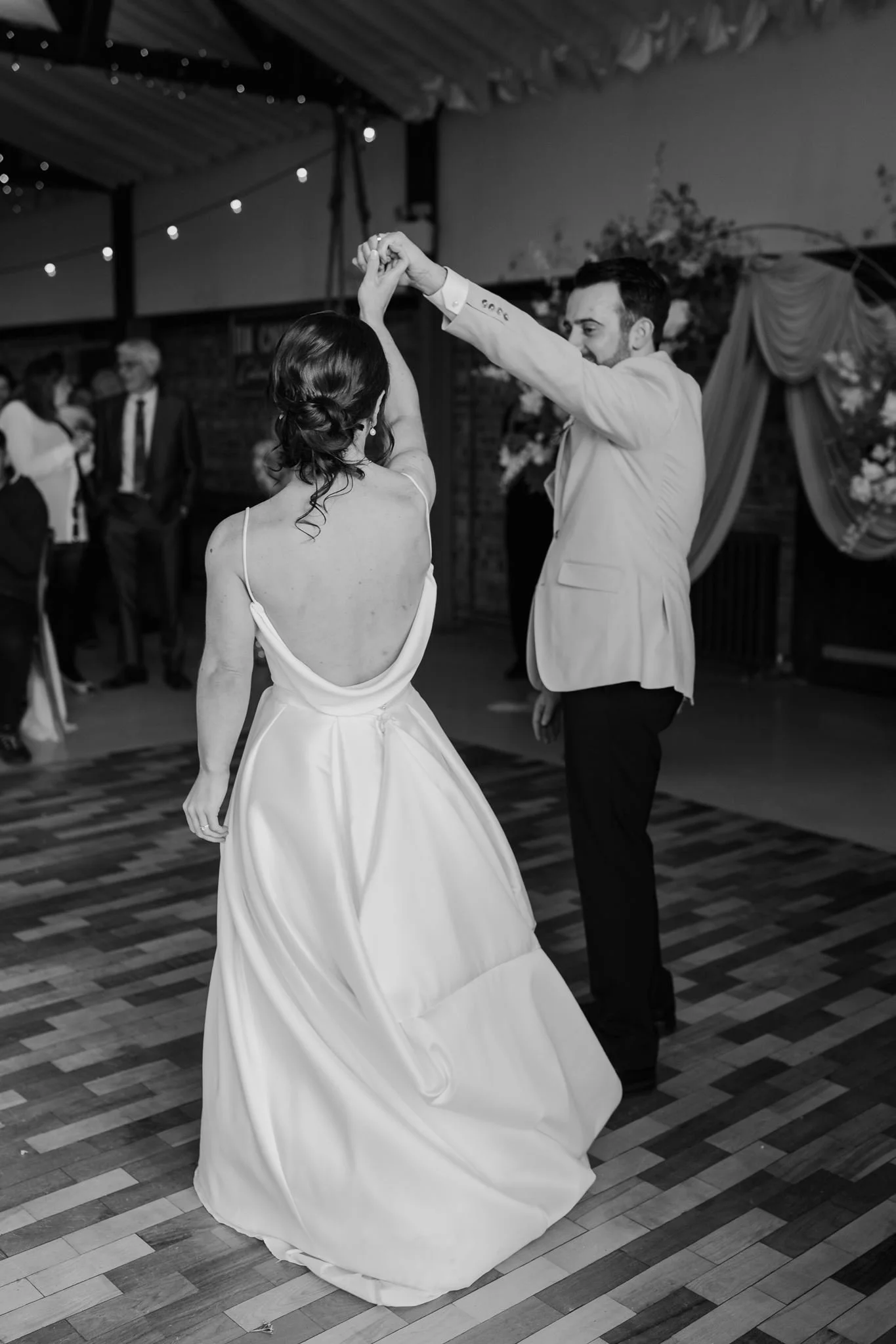 Harry twirling Rachel on the dance floor, in black and white