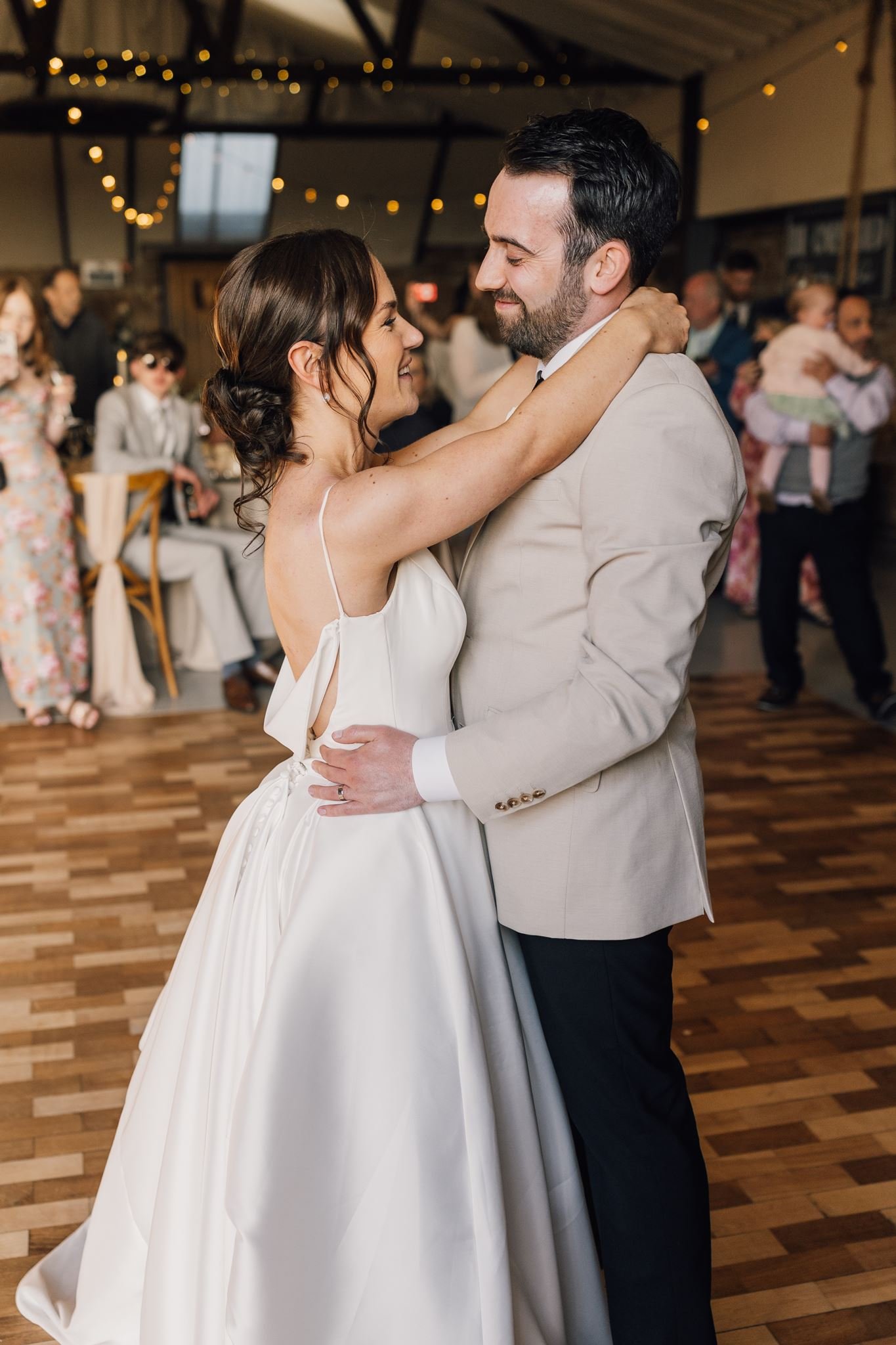 Rachel and Harry embracing during their first dance at The Beverley Barn