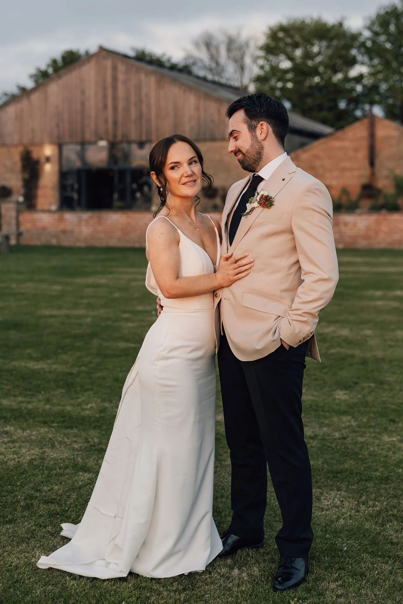 Rachel and Harry laughing together with the barn in the background