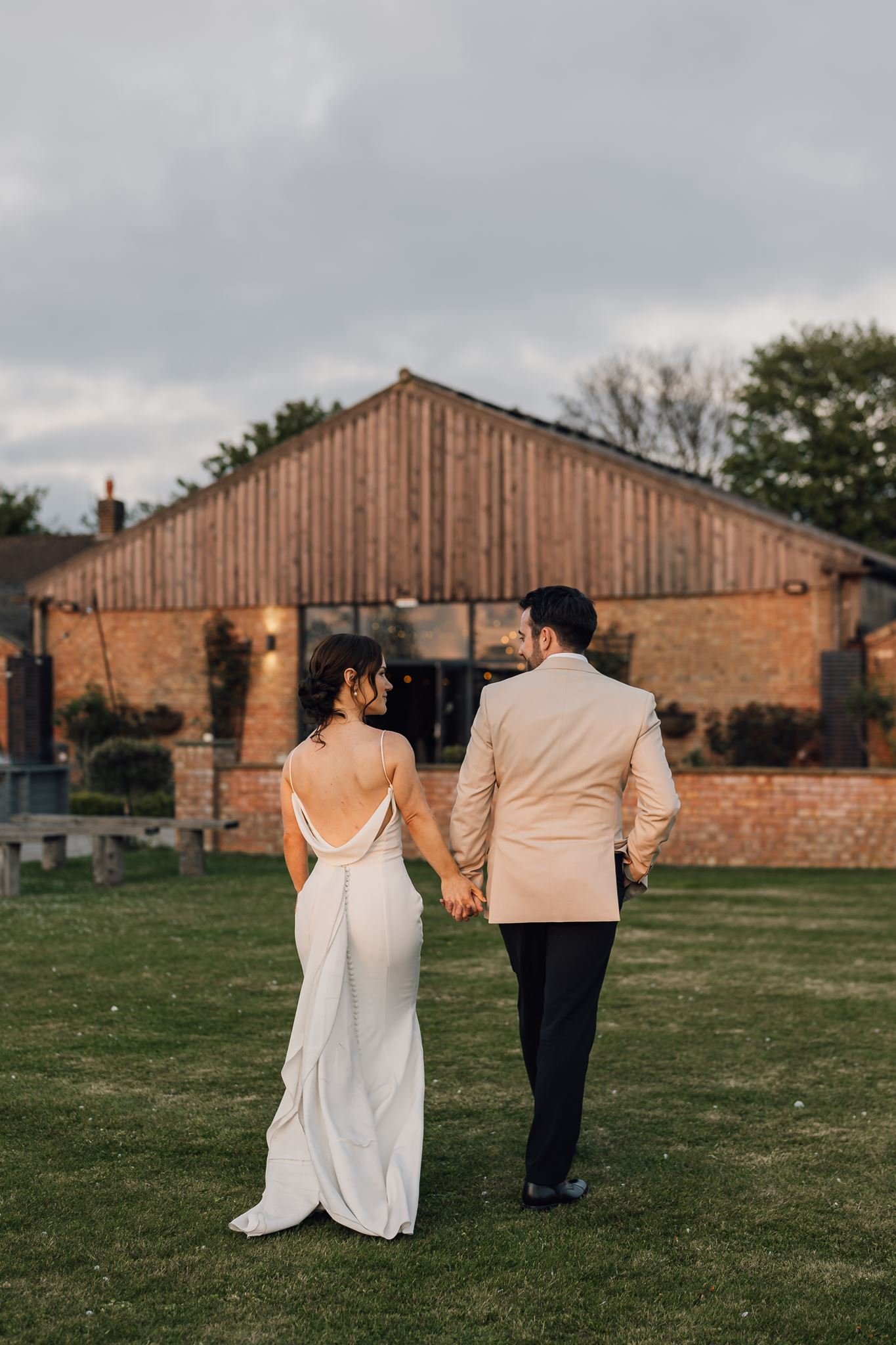 Rachel and Harry walking back towards the barn after their evening portraits