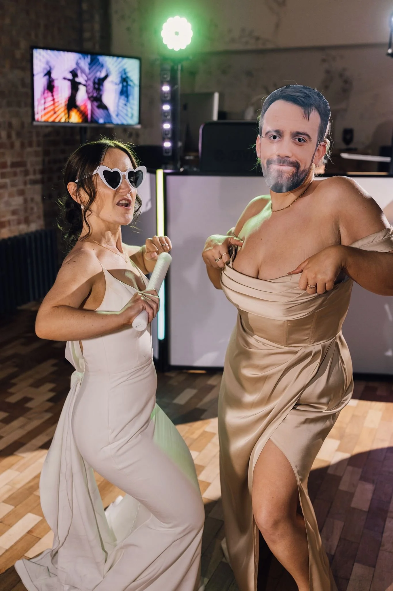 Rachel laughing with a guest on the wedding dance floor