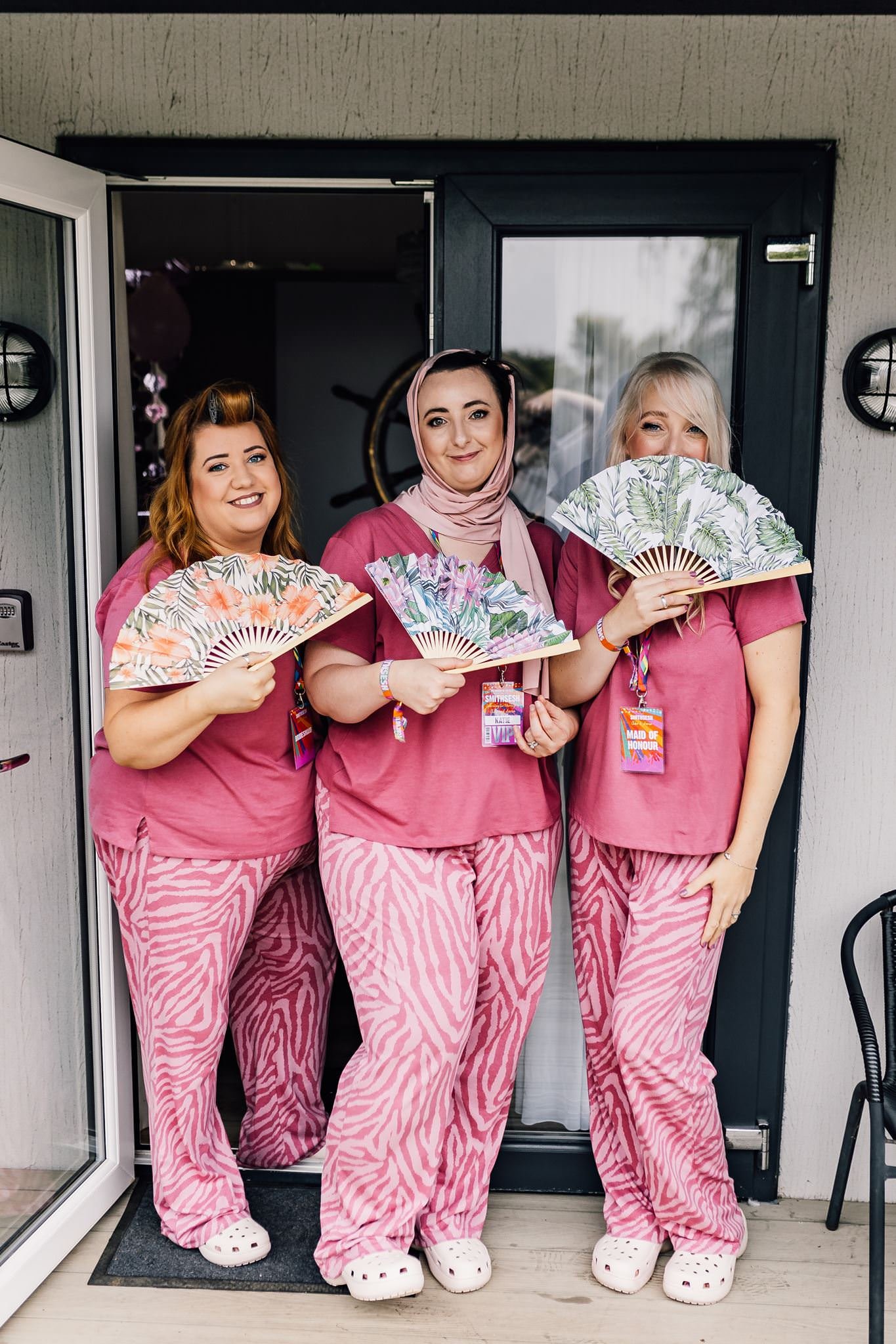 Chloe and two women in pink pyjamas sharing a laugh during wedding preparations