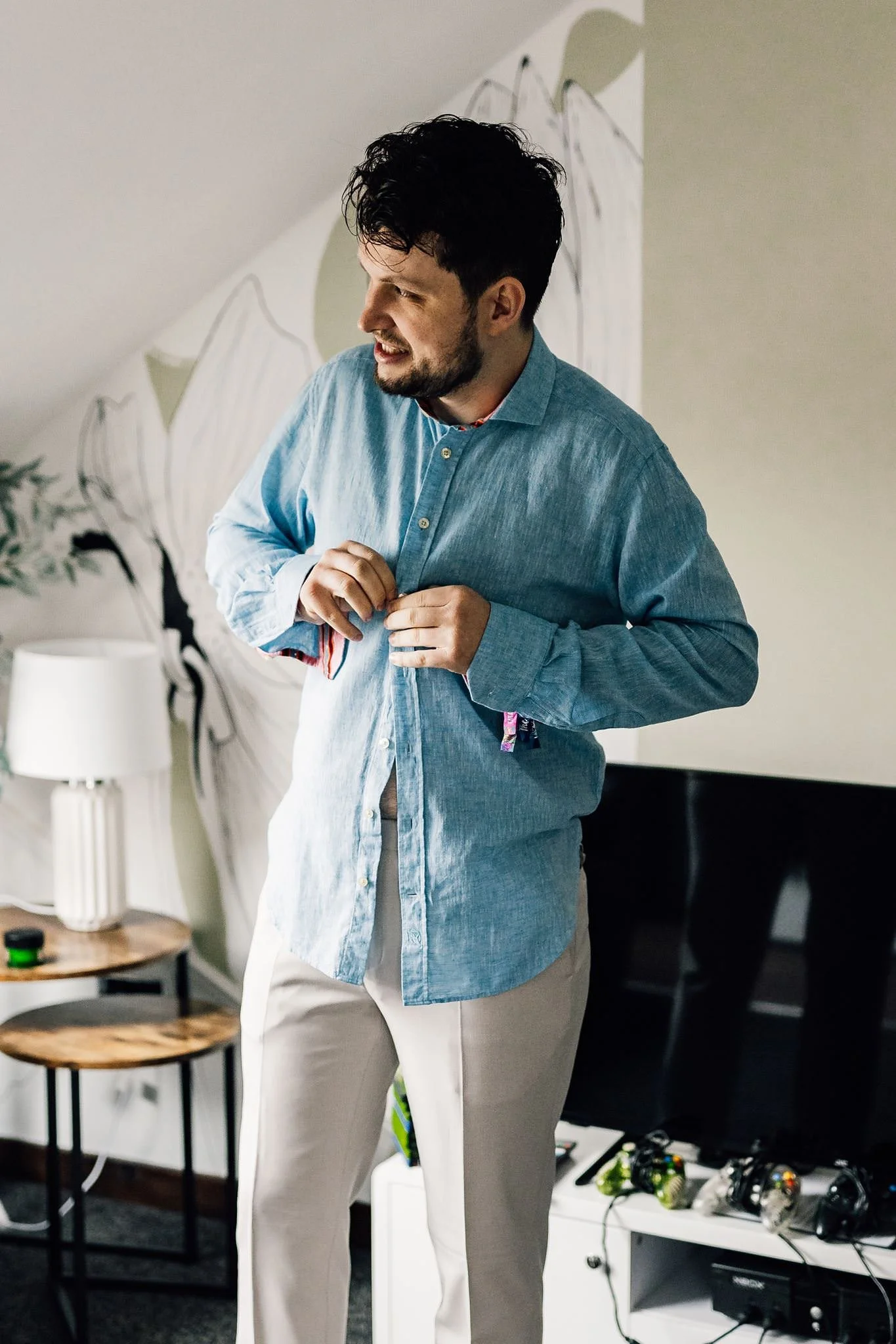 Aaron adjusting his cuff while getting ready for his wedding