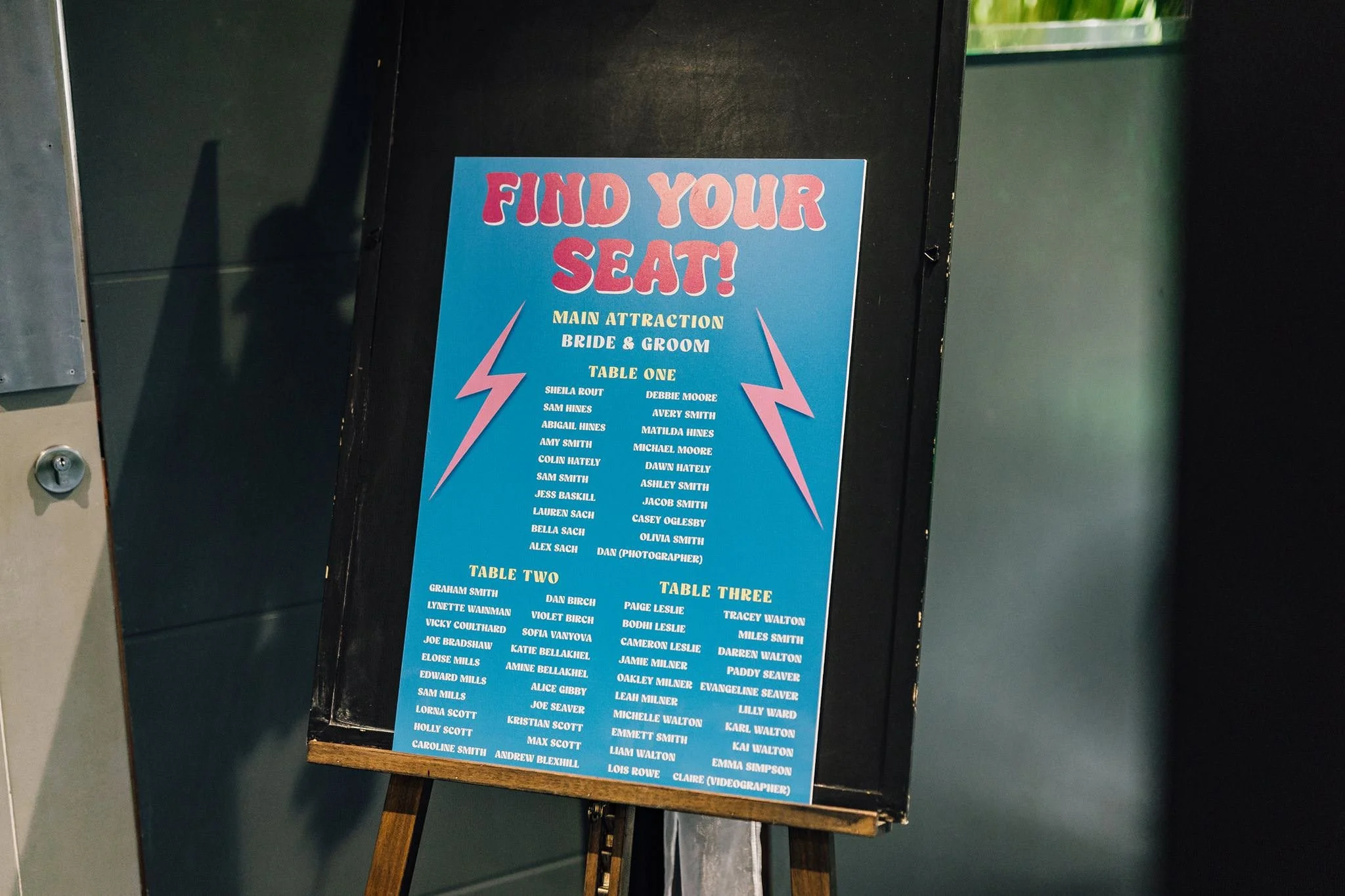 Brightly coloured ‘Find your seat’ wedding table plan