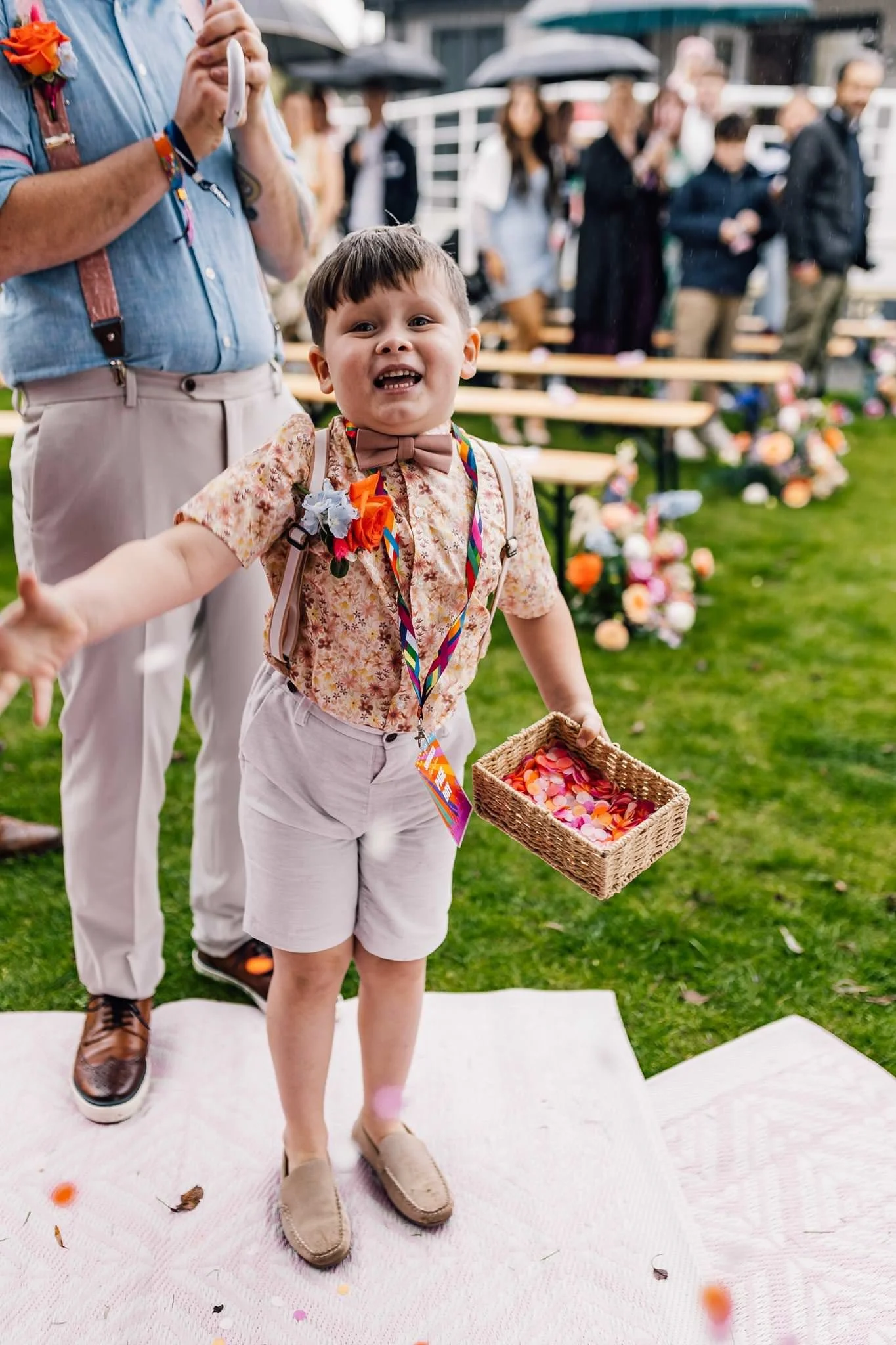 A young guest walking along the outdoor ceremony aisle