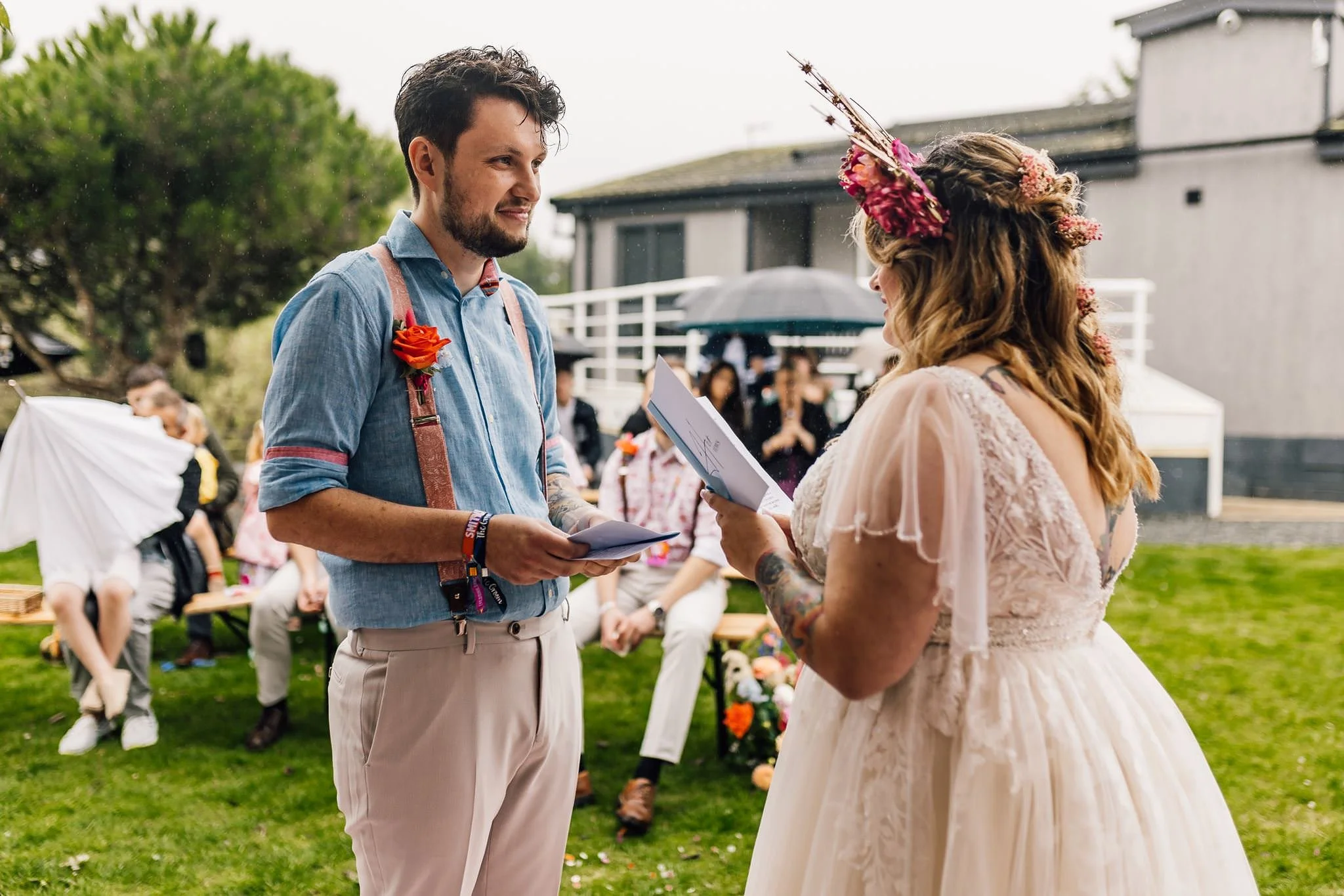 Chloe and Aaron holding hands during their outdoor ceremony