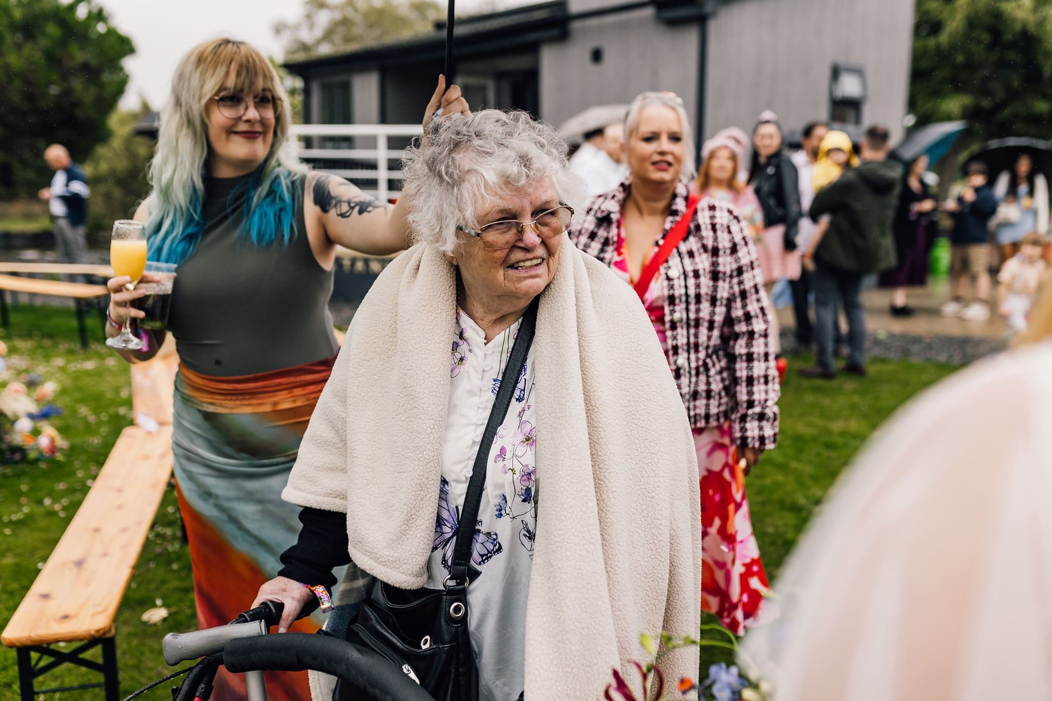 A wedding guest clapping and smiling after the ceremony