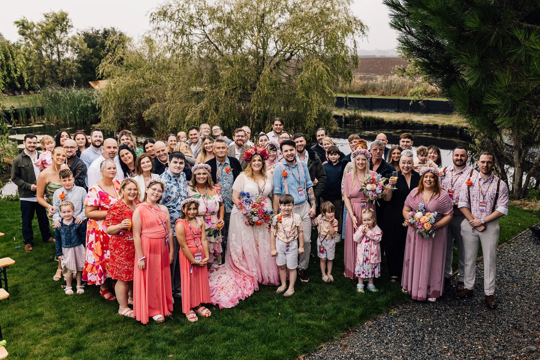 Chloe and Aaron’s wedding guests gathered for a group photograph on the lawn