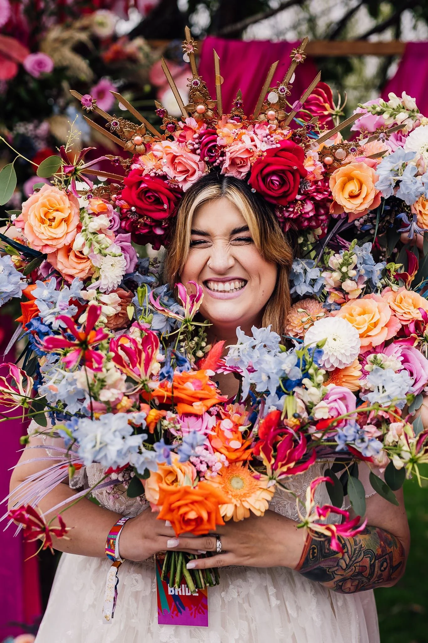 Chloe’s smiling face framed by colourful wedding bouquets