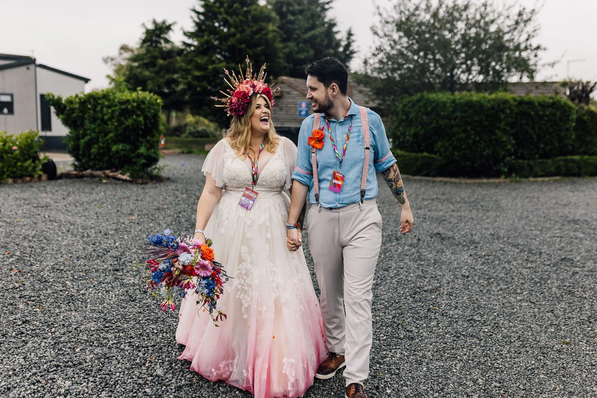 Chloe and Aaron walking hand in hand along a gravel path