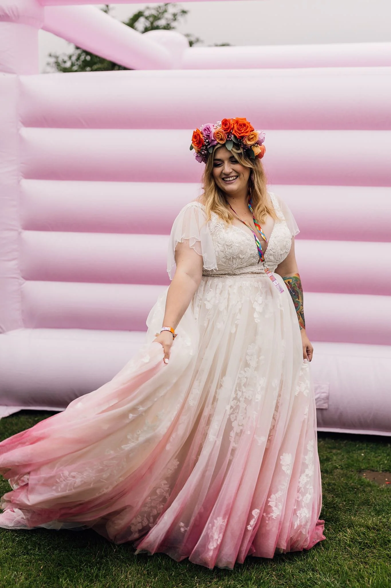 Chloe showing the pink hem of her wedding dress on the bouncy castle