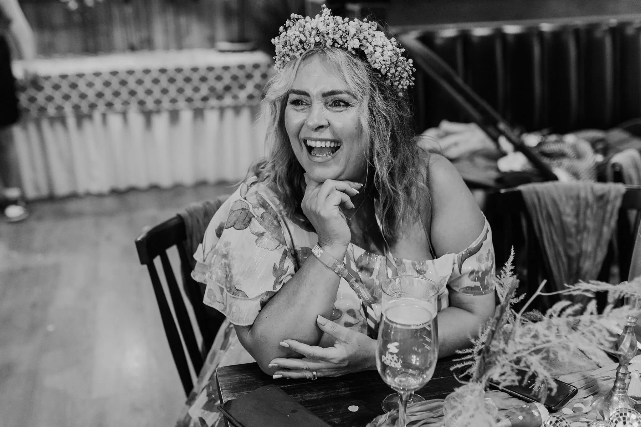 Black and white photograph of Chloe laughing during the speeches