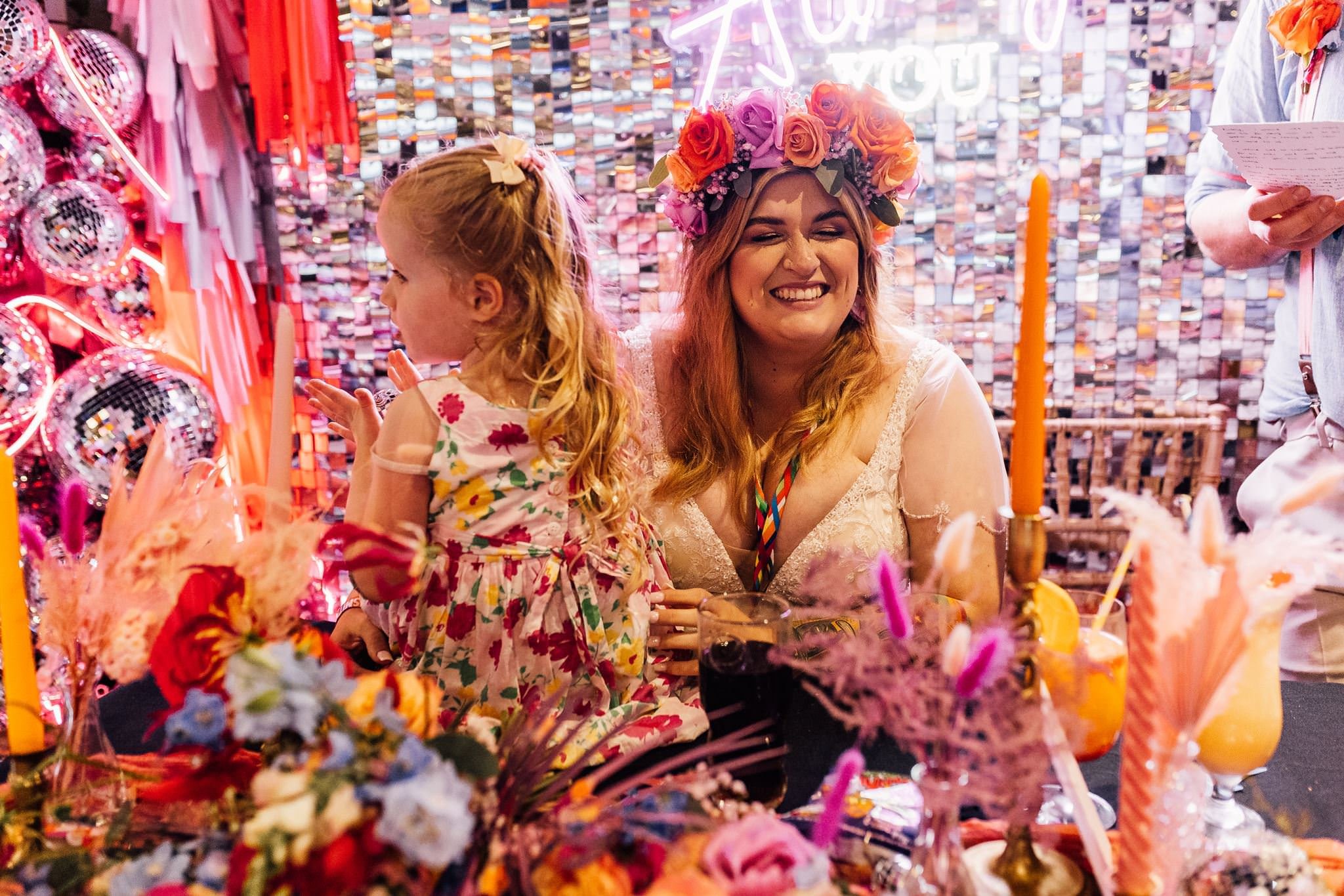 Chloe and a young guest laughing at the reception table