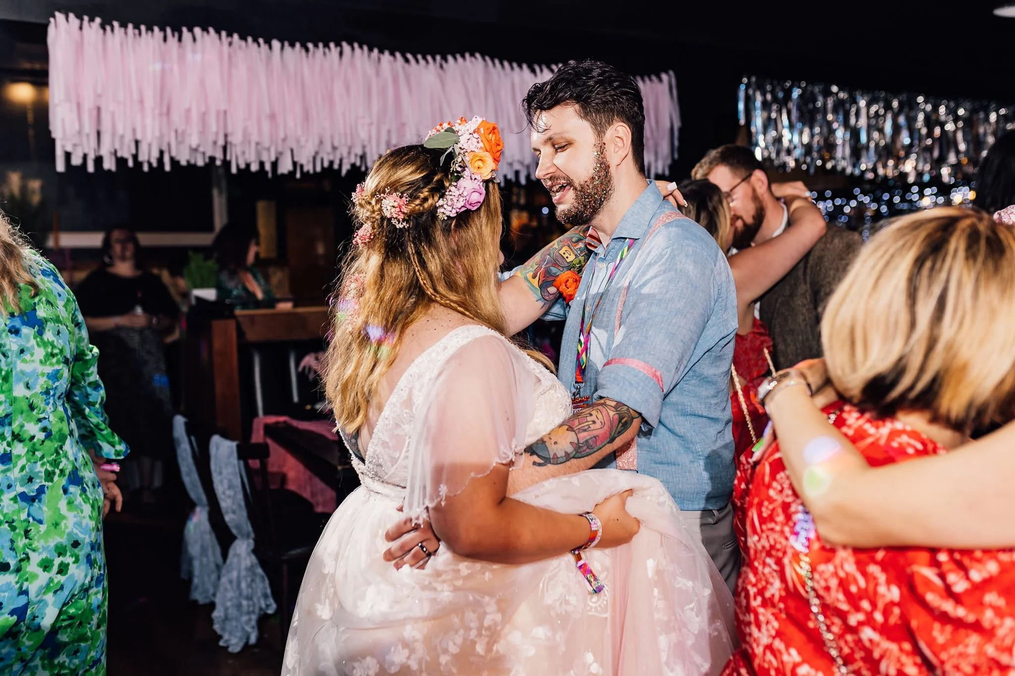 Chloe and Aaron dancing together as guests join the dance floor