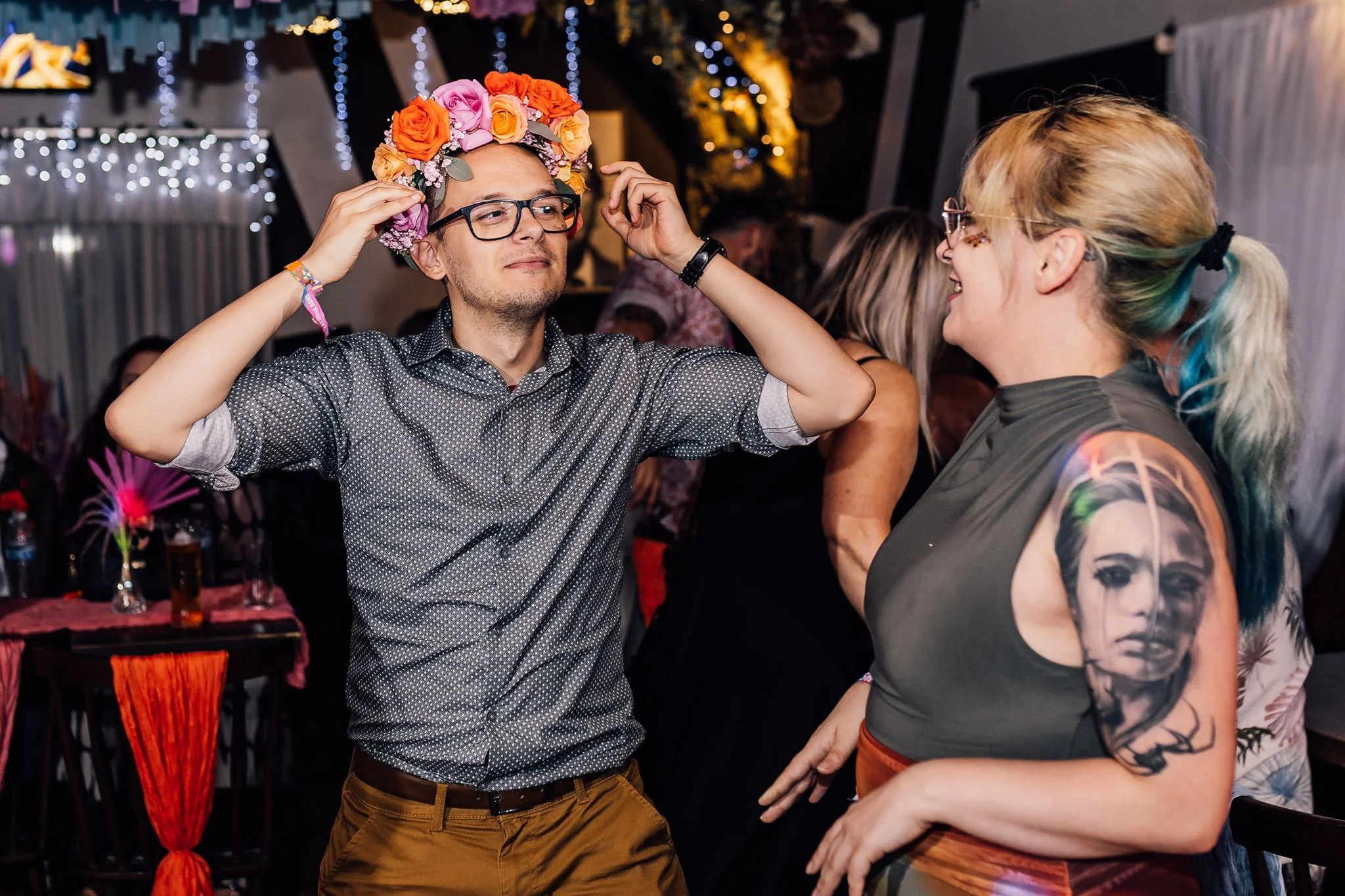 A guest dancing with a colourful flower crown