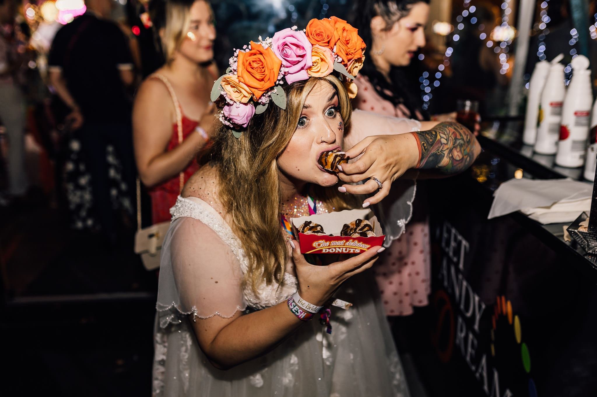 A guest in a floral headpiece enjoying the wedding dance floor