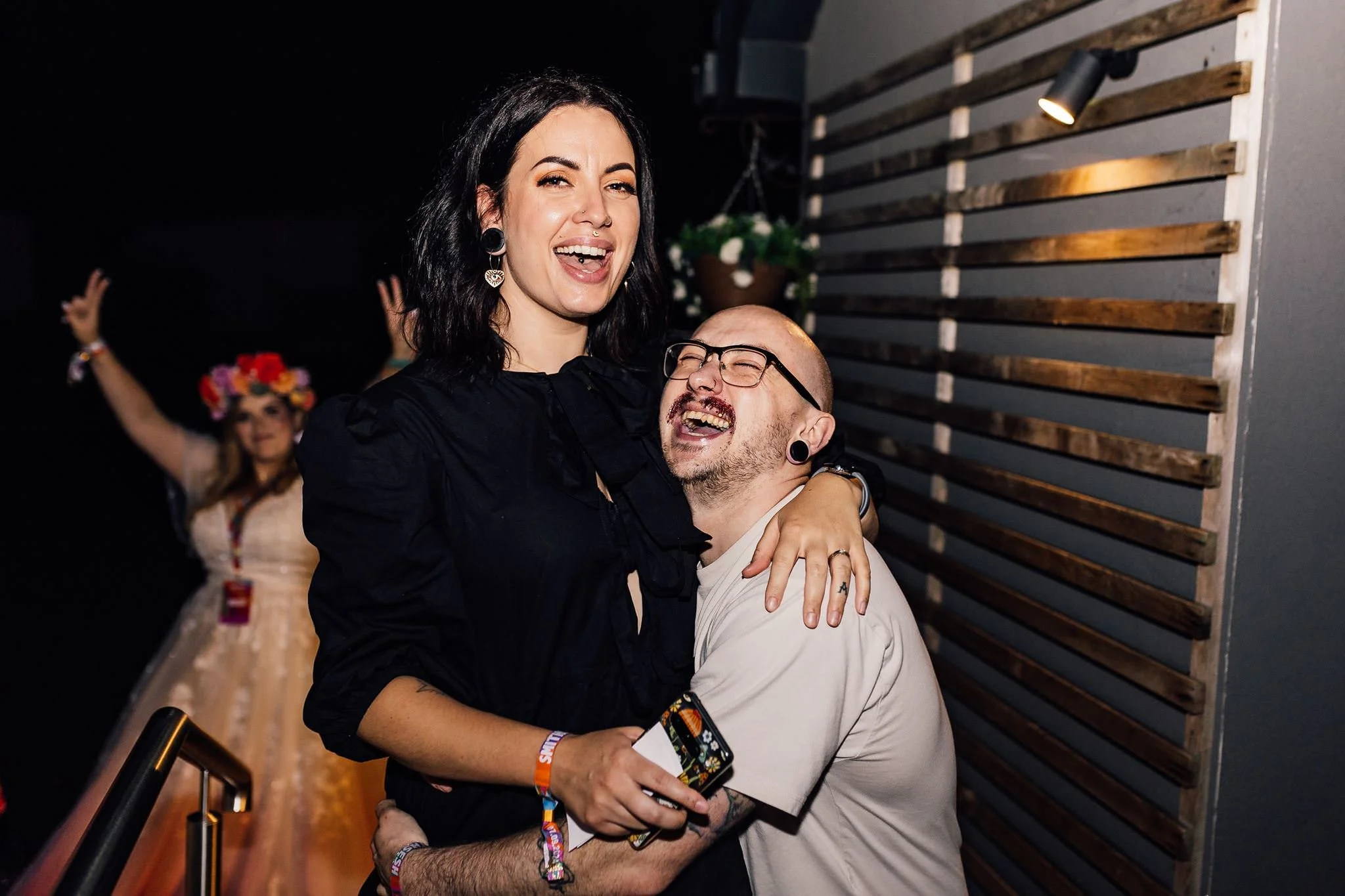 Wedding guests sharing a laugh outside during the evening