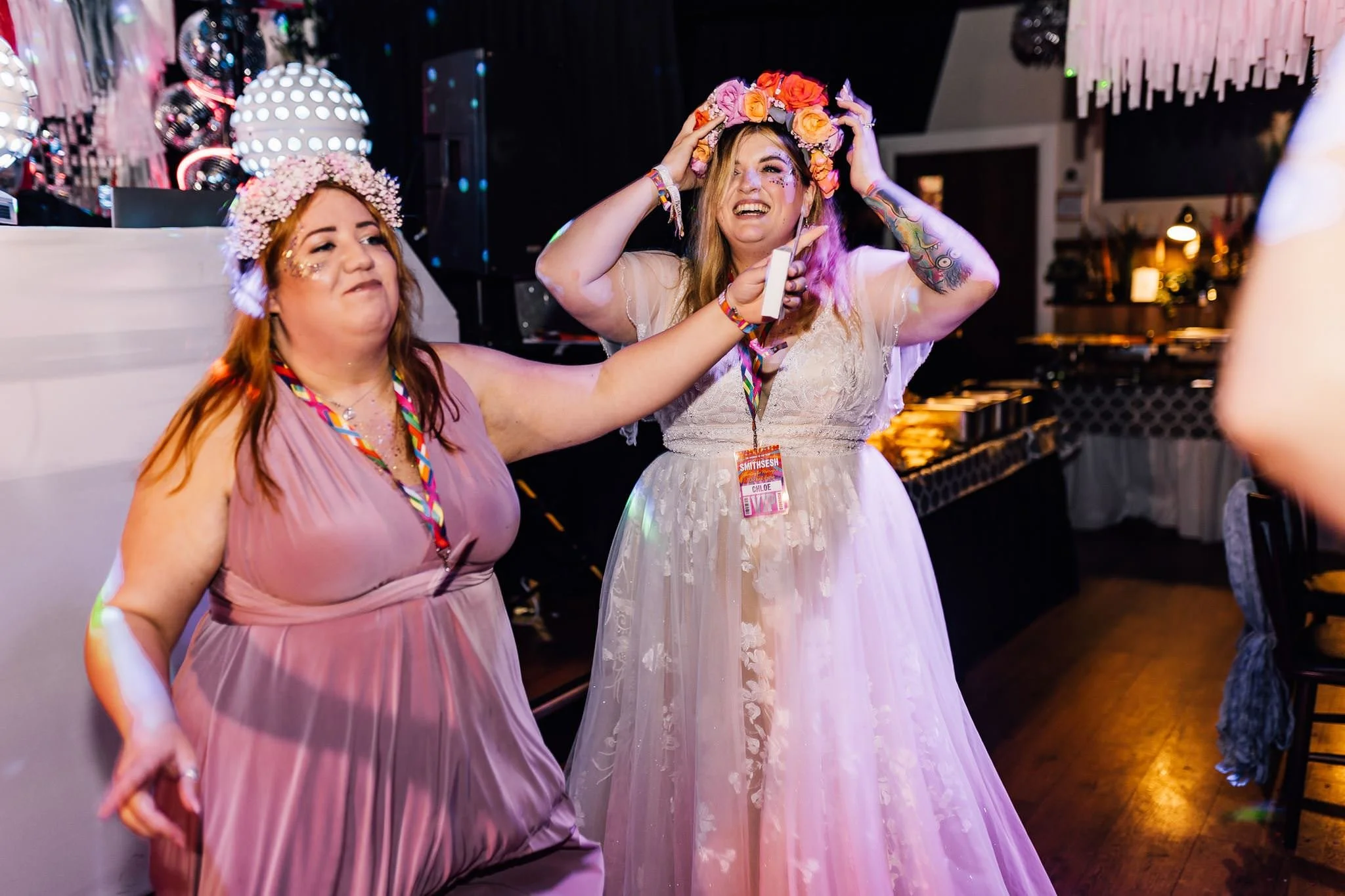 Chloe and a guest dancing beneath the reception streamers