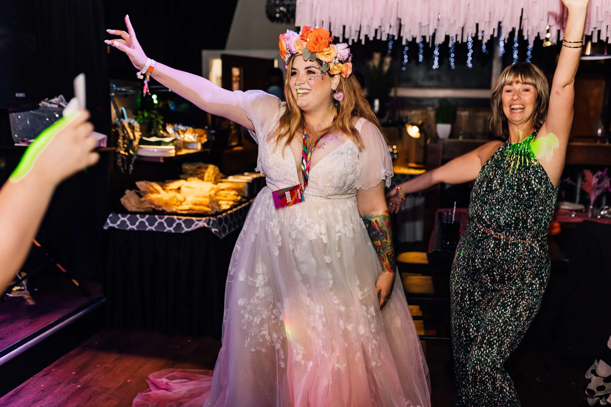 Chloe dancing with her arms raised at her festival wedding