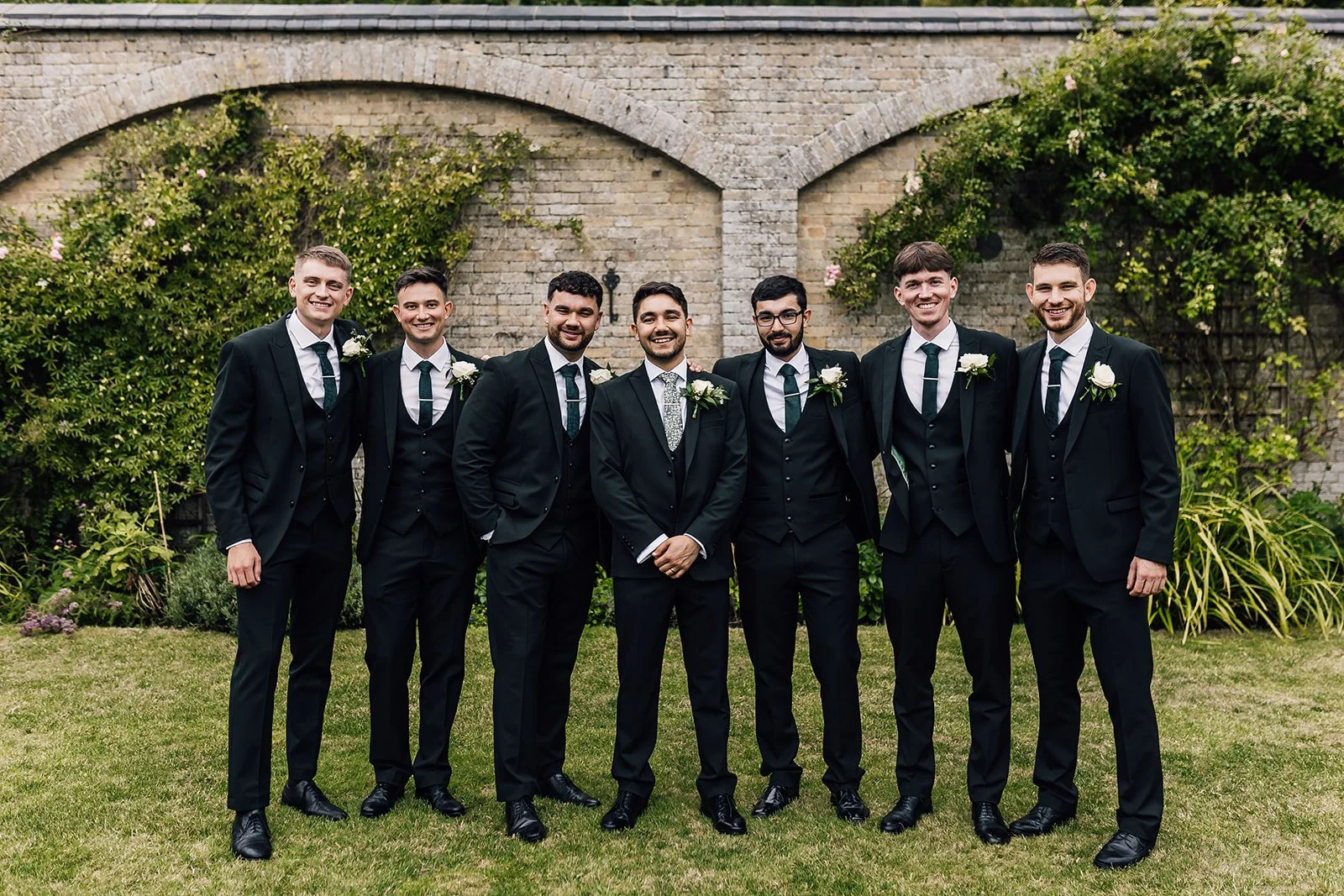 Rory and his groomsmen beside the wall at Scrivelsby
