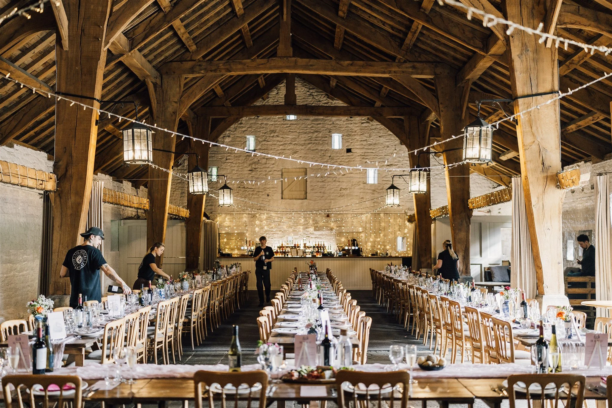 Wedding reception setup inside East Riddlesden Hall with long tables and rustic beams