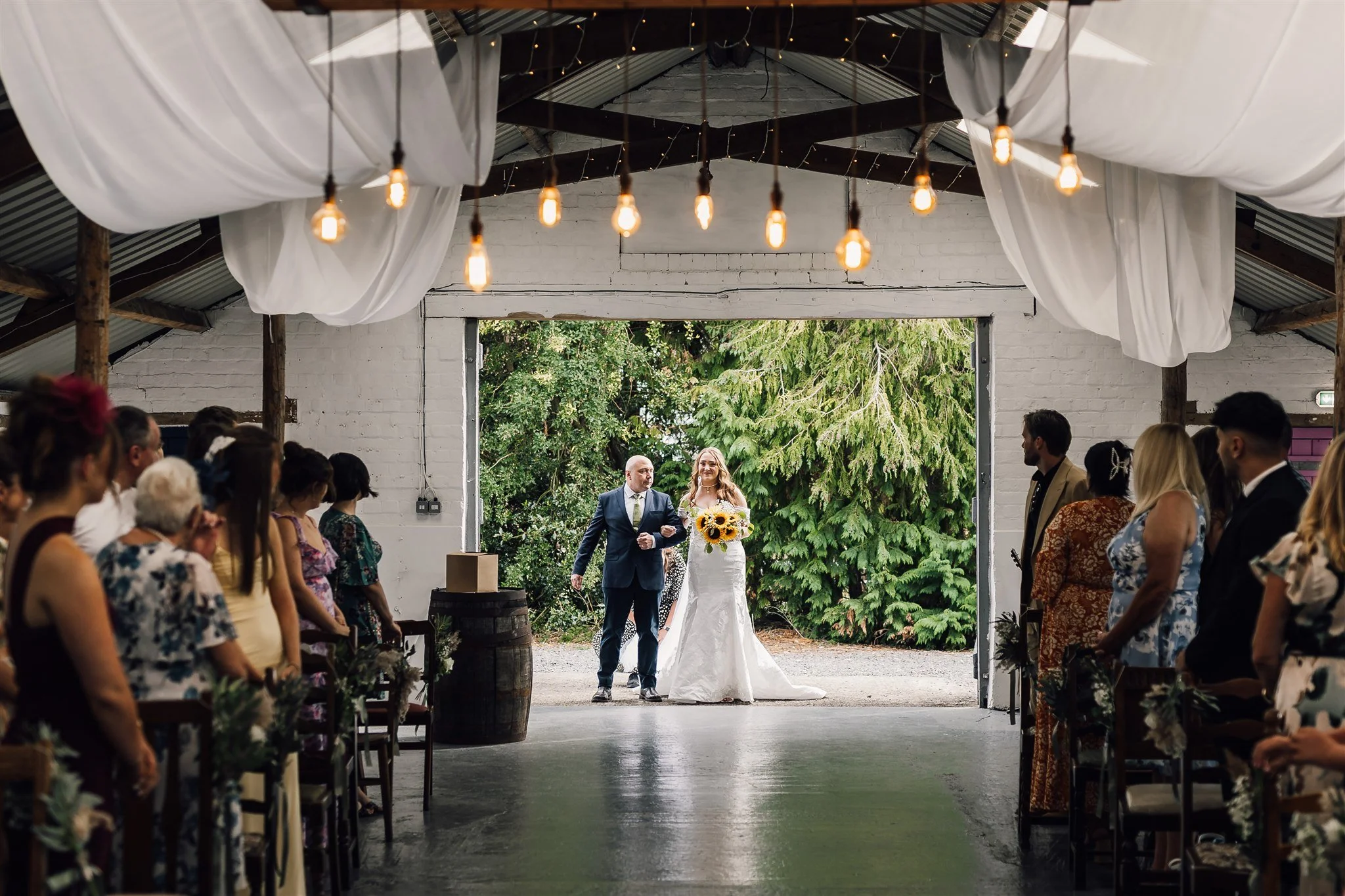 Father and Bride about to walk down the isle inside The Piggery