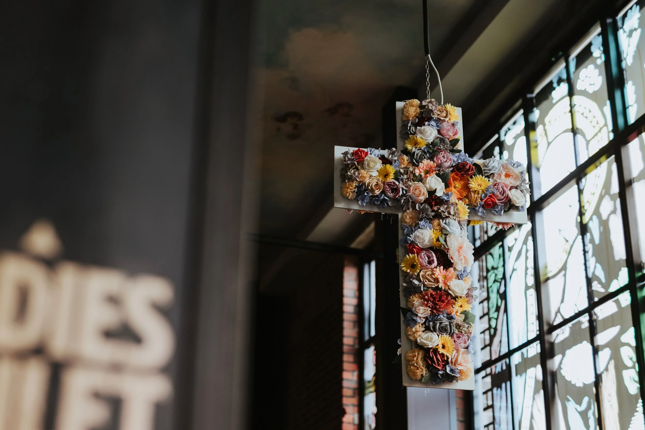 Floral cross decoration inside Church Temple of Fun wedding venue Sheffield
