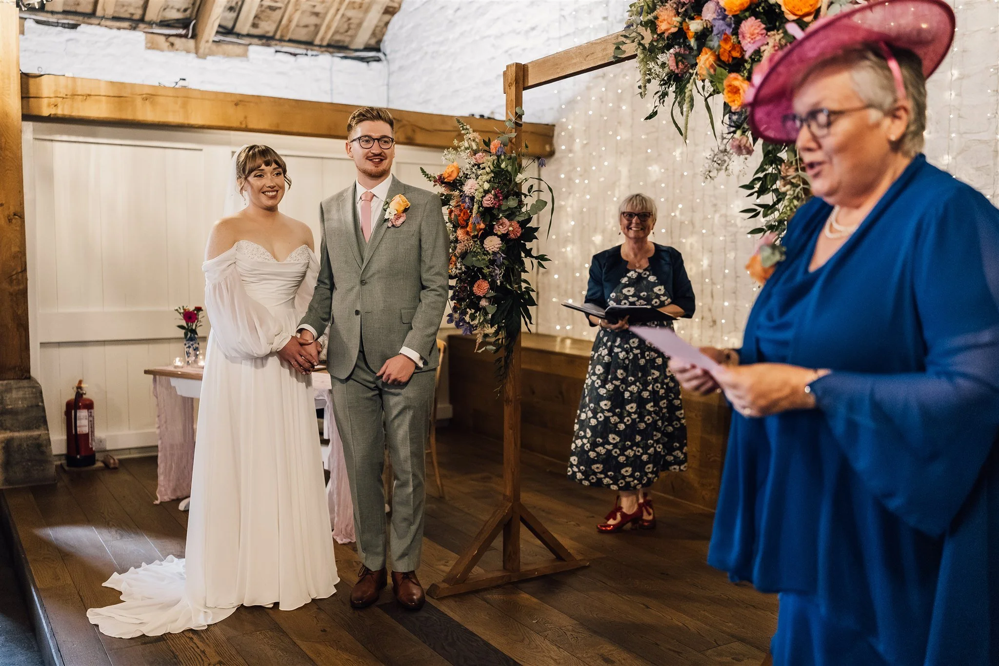 Wedding ceremony taking place at East Riddlesden Hall with couple and celebrant