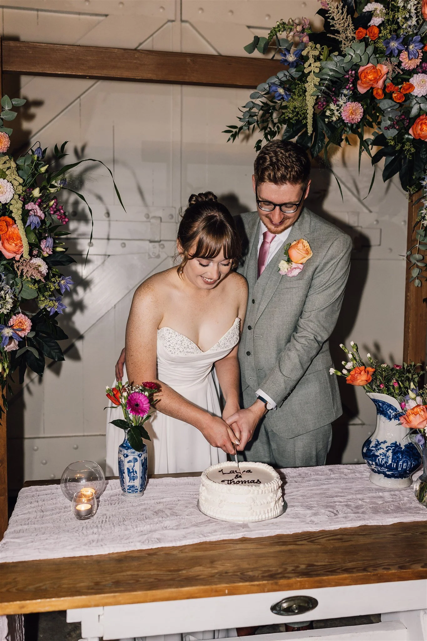 Bride and groom cutting their wedding cake at East Riddlesden Hall