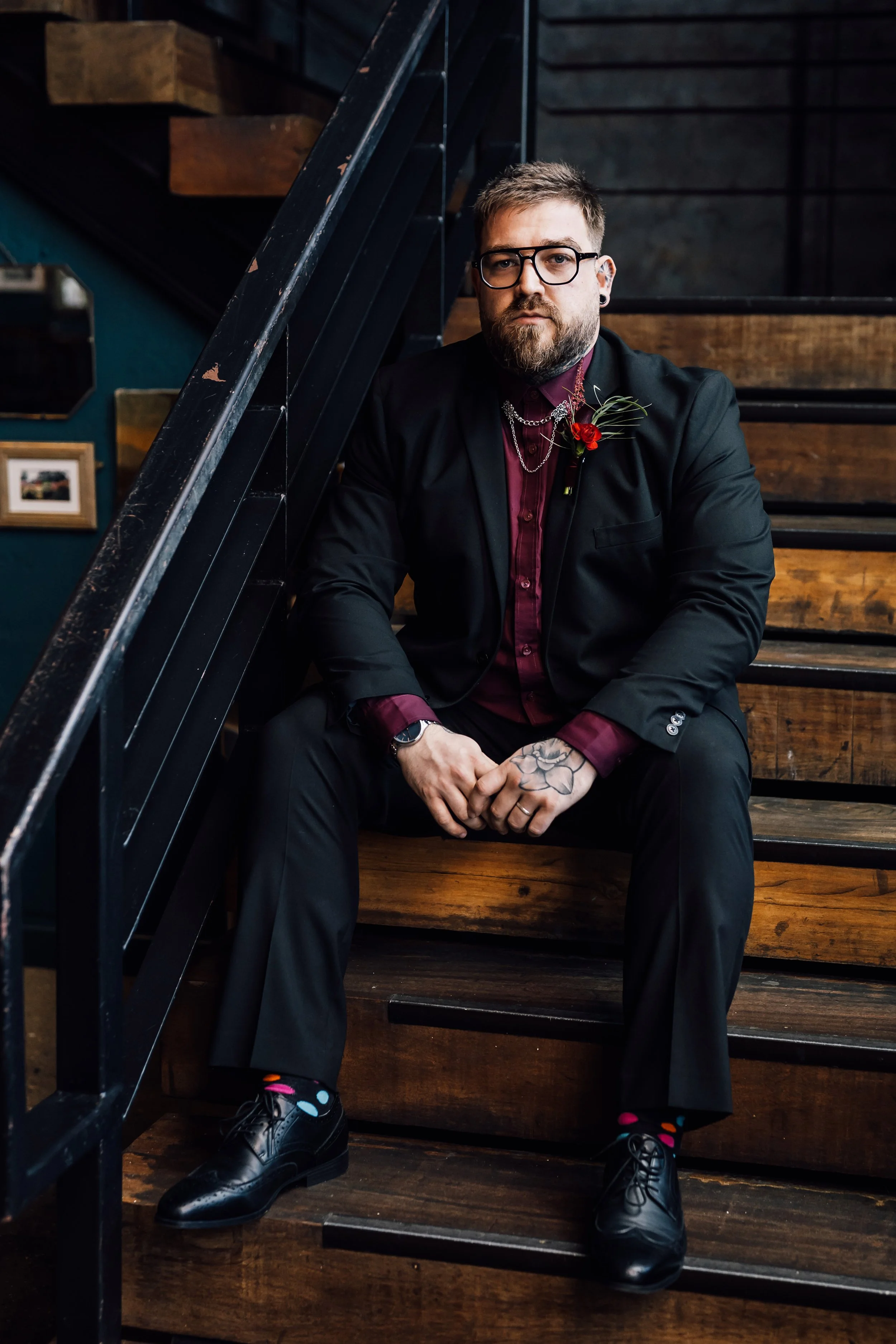Alternative groom portrait ideas with tattoos and dark wedding styling