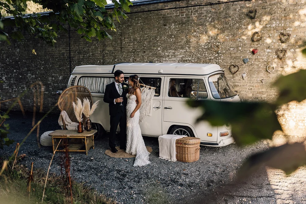 Charlotte and Rory beside the white campervan photo booth