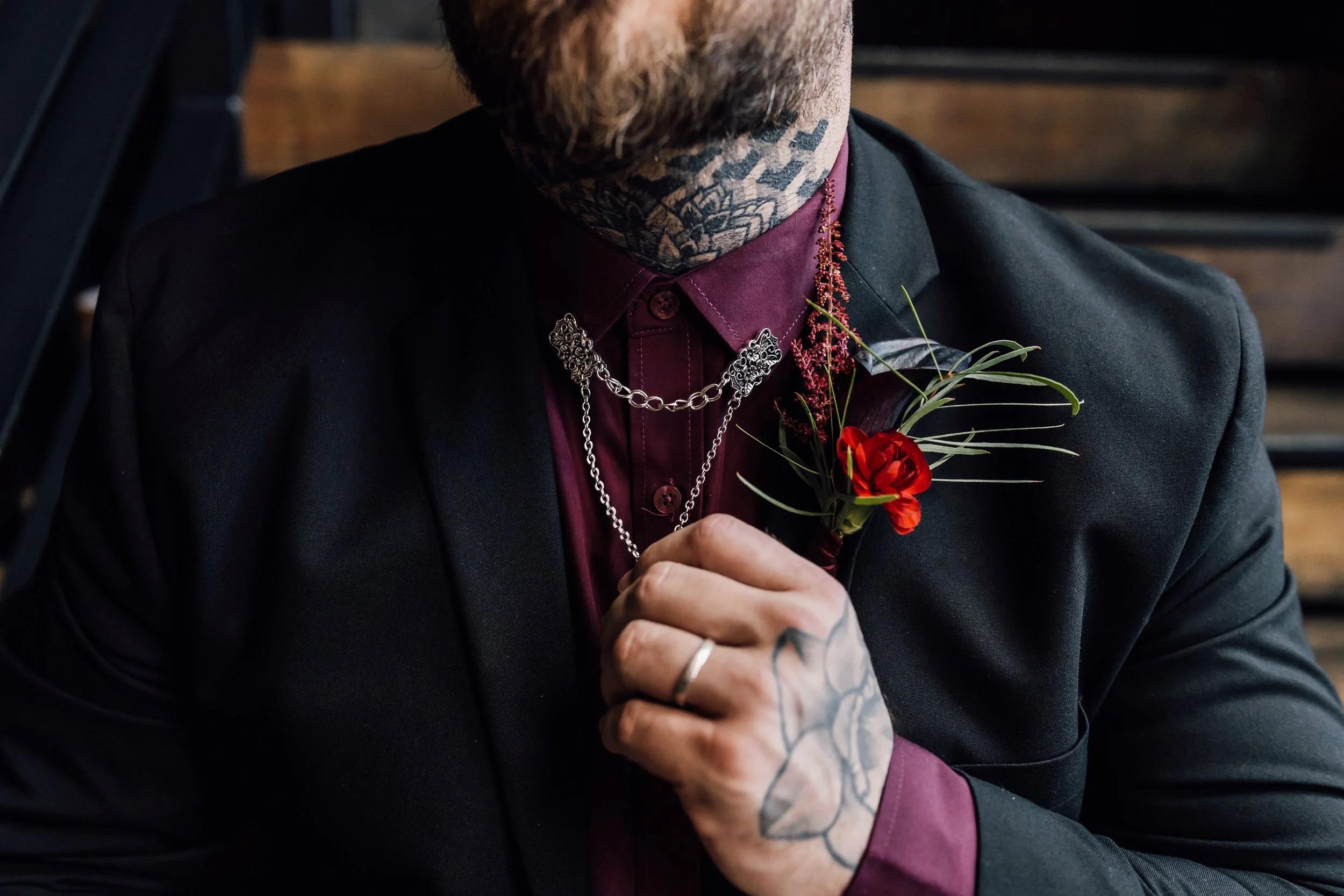 Alternative groom style with tattoos, chains and boutonniere wedding ideas