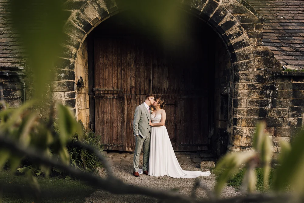 Laura and Tom together beneath a stone arch at East Riddlesden Hall