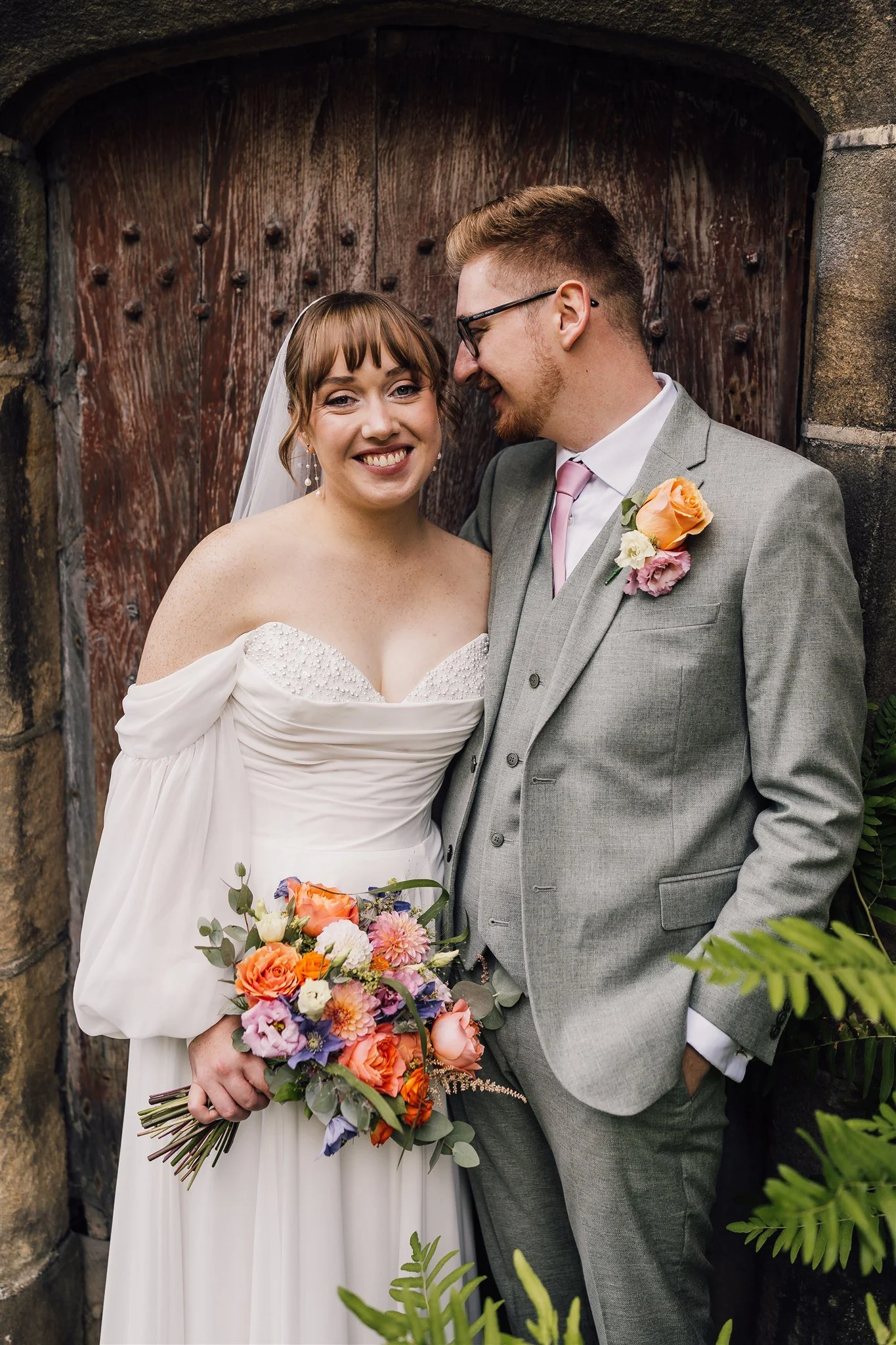 Wedding couple portrait at East Riddlesden Hall with rustic wooden door backdrop