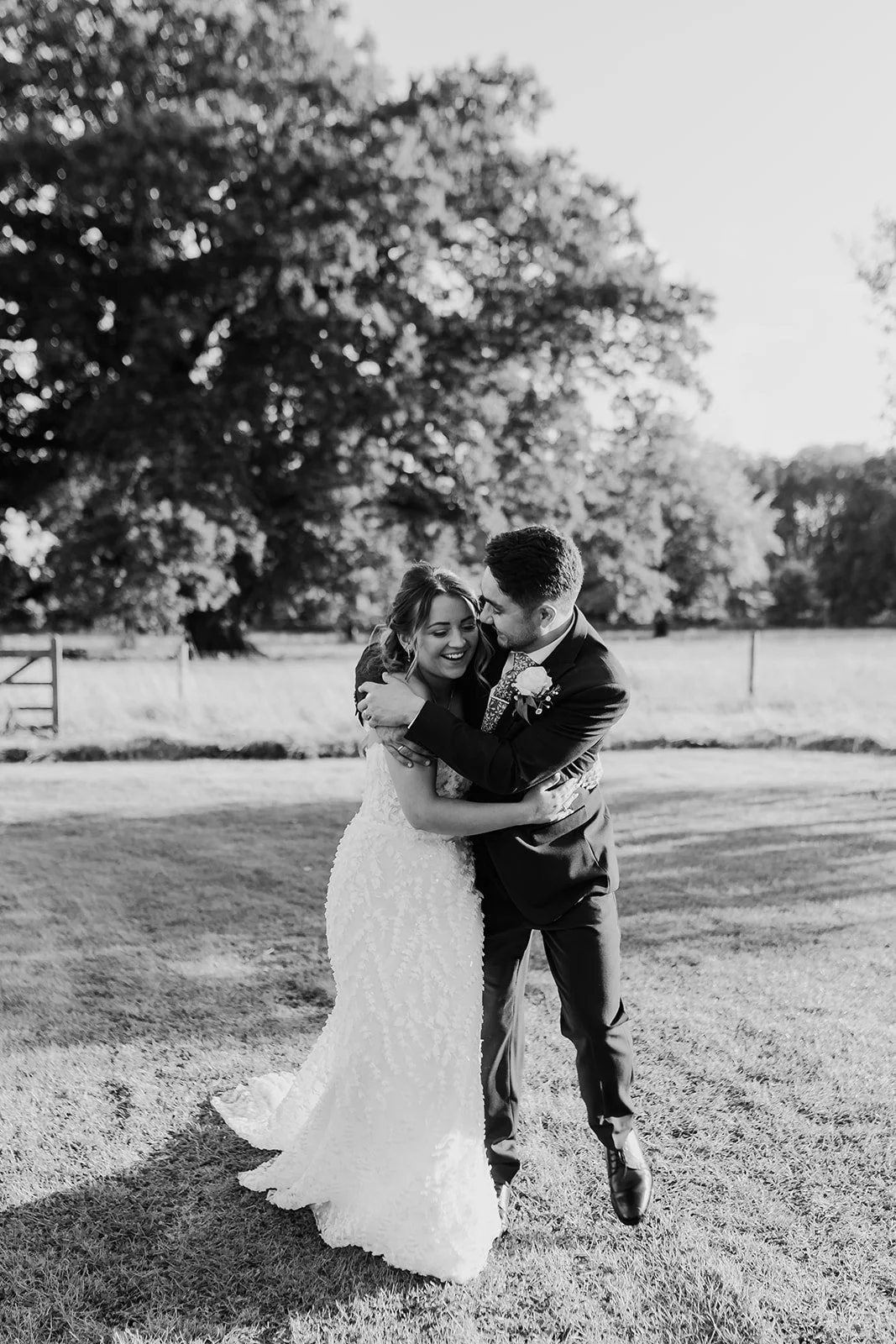 Black and white portrait of Charlotte and Rory beneath a large tree