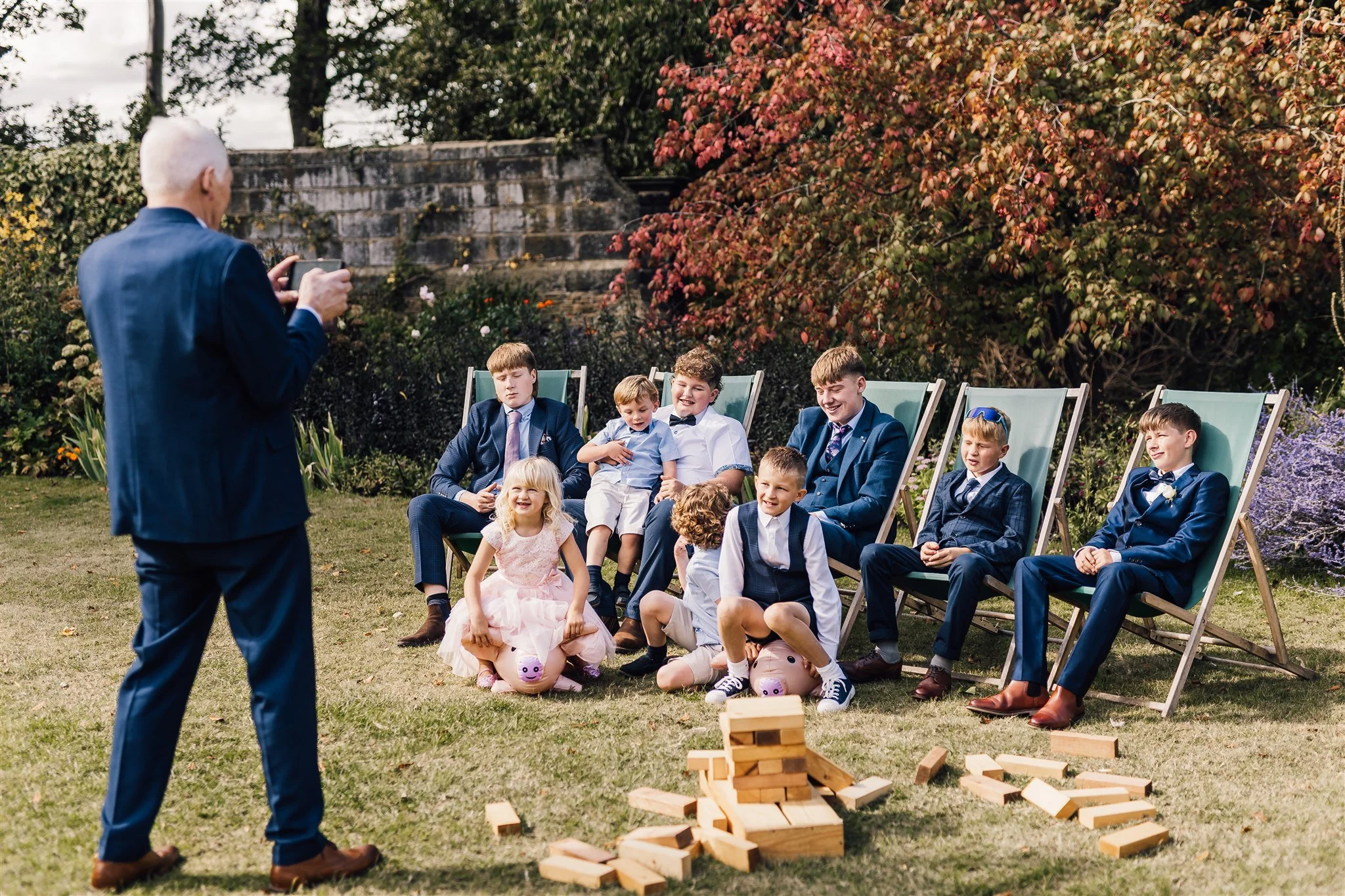 Wedding guests and children relaxing in the gardens at East Riddlesden Hall in West Yorkshire