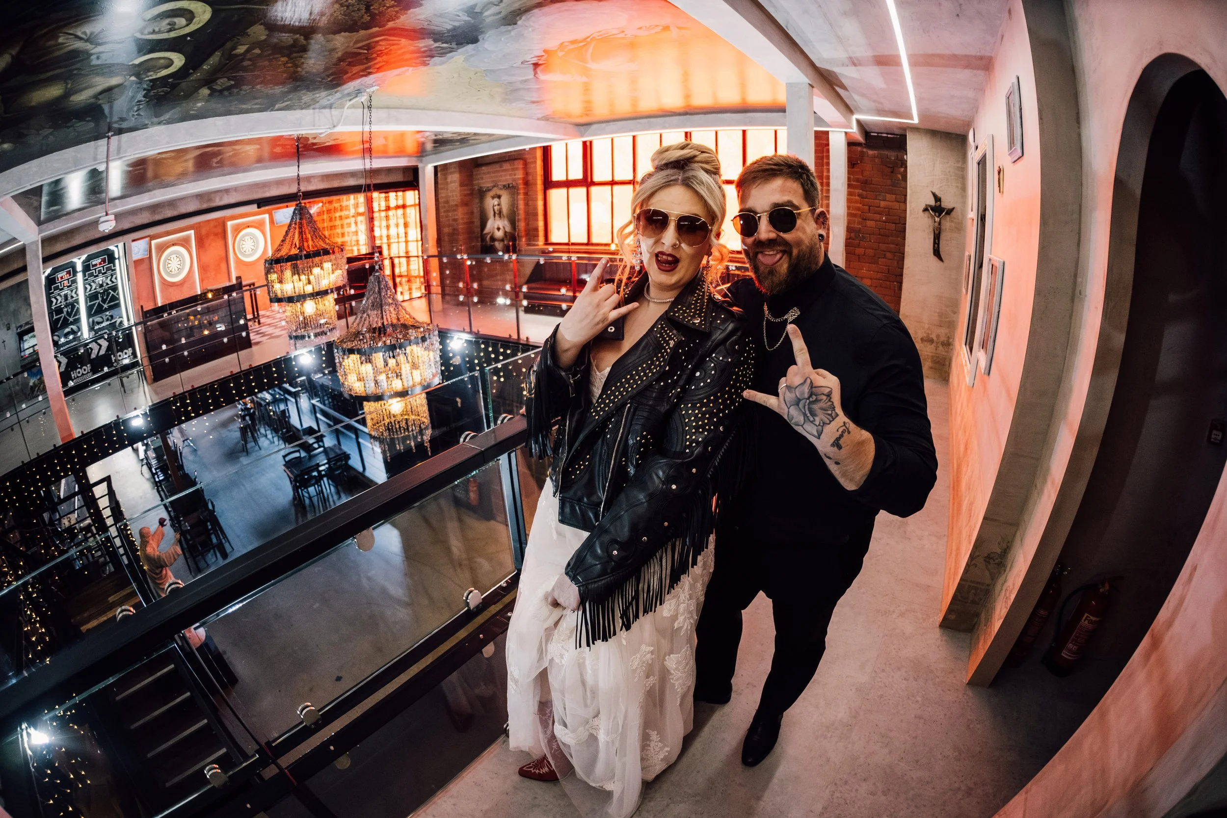 Alternative wedding couple with sunglasses at Church Temple of Fun Sheffield balcony portrait