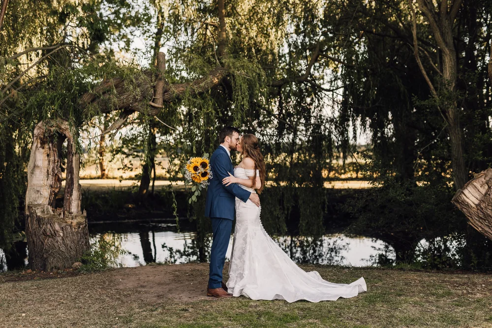 Lauren and Ben sharing a kiss beneath the trees at White Syke Fields