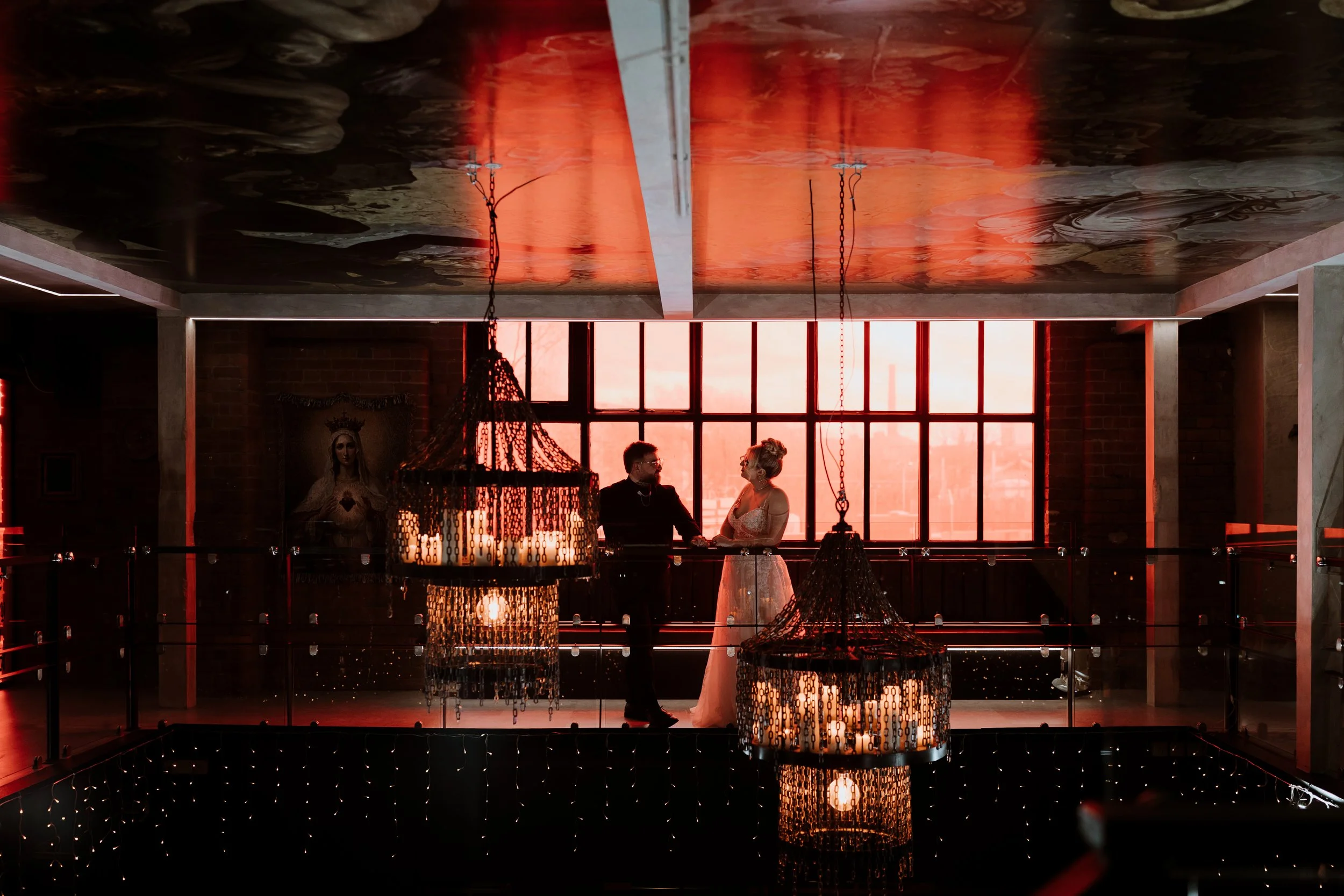 Church Temple of Fun wedding photography Sheffield with couple on mezzanine balcony and dramatic red lighting