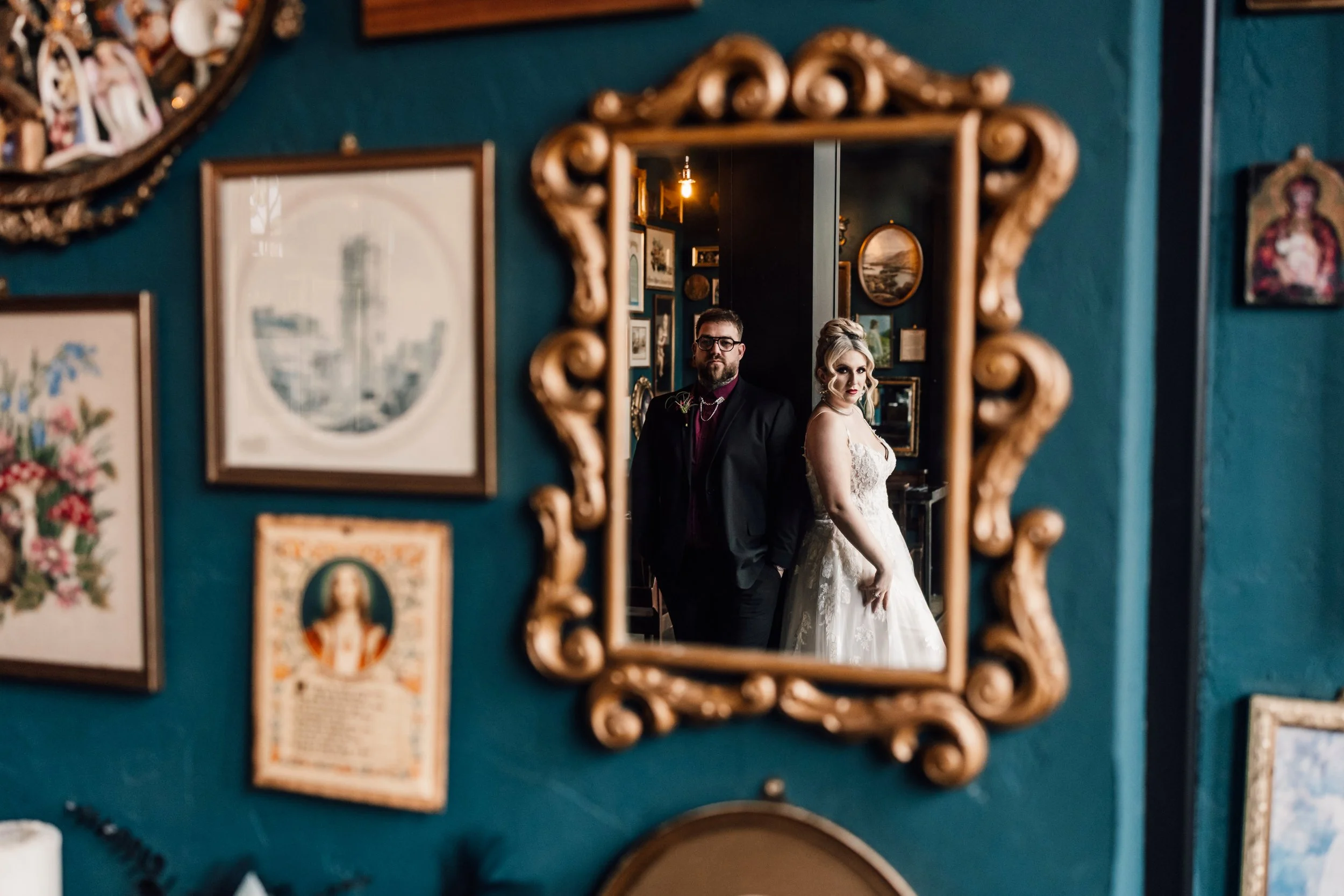 Alternative wedding couple reflected in vintage mirror at Church Temple of Fun Sheffield wedding venue
