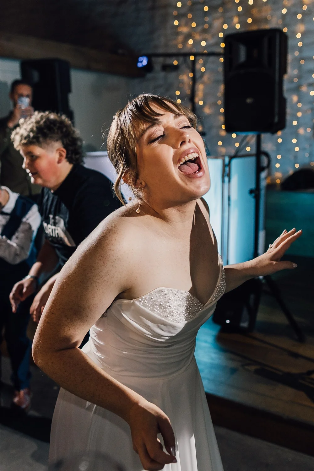 Laura singing and dancing during her evening wedding reception at East Riddlesden Hall