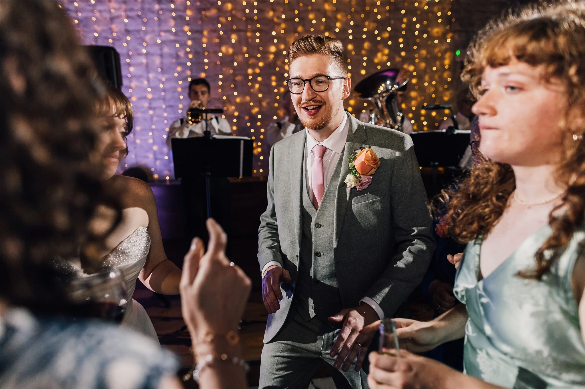 Groom dancing with guests at East Riddlesden Hall wedding reception with live band