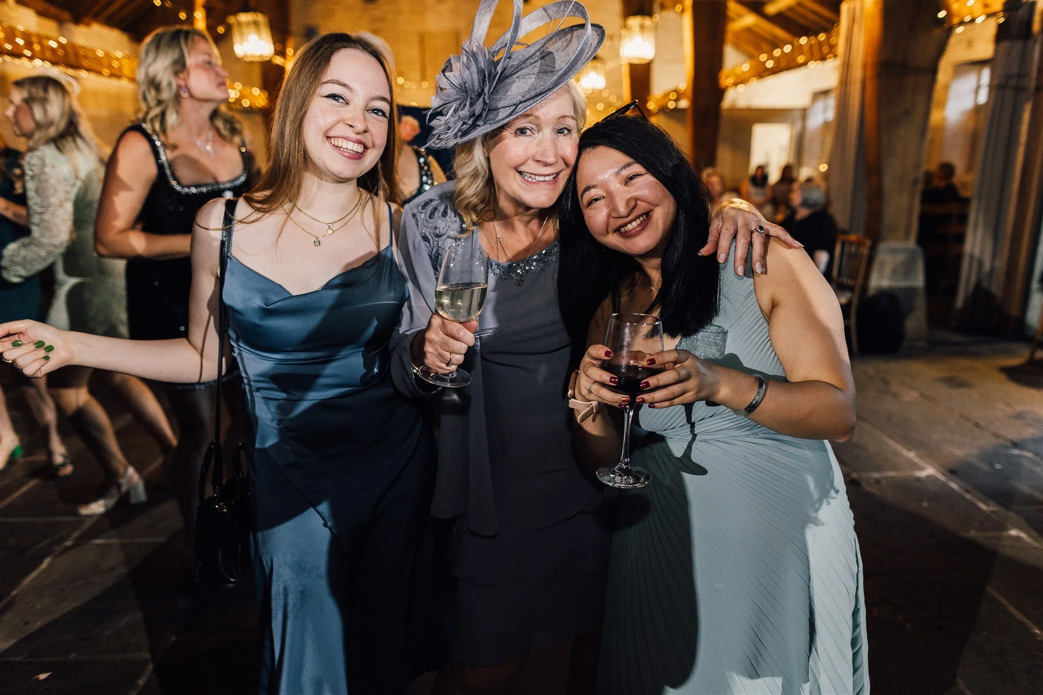 Wedding guests celebrating and smiling during reception at East Riddlesden Hall
