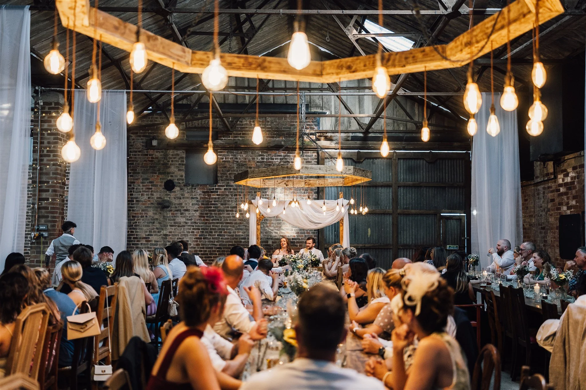 Bride and groom enjoying speeches White Syke Fields