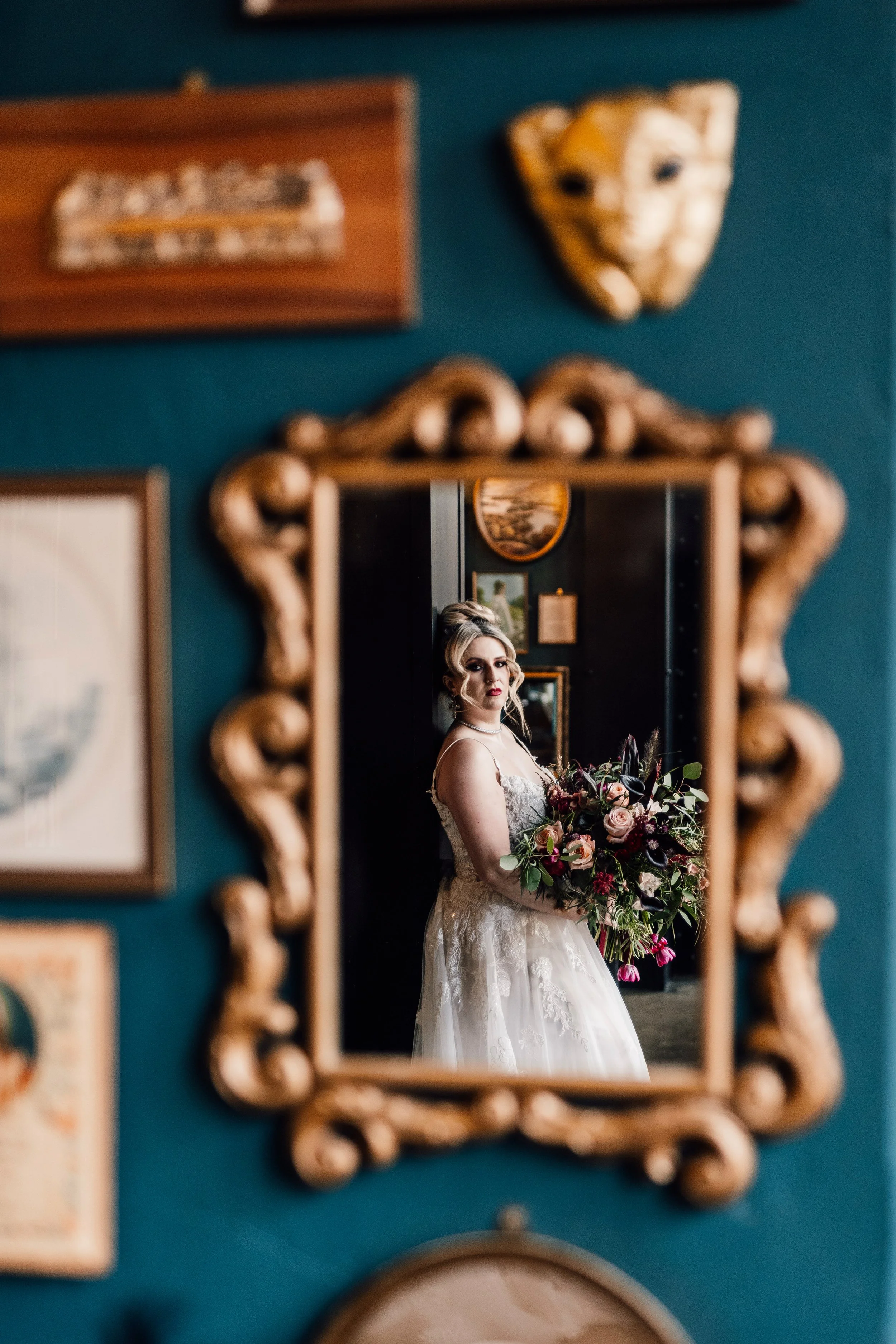 Bride holding bouquet reflected in ornate mirror at Church Temple of Fun Sheffield wedding